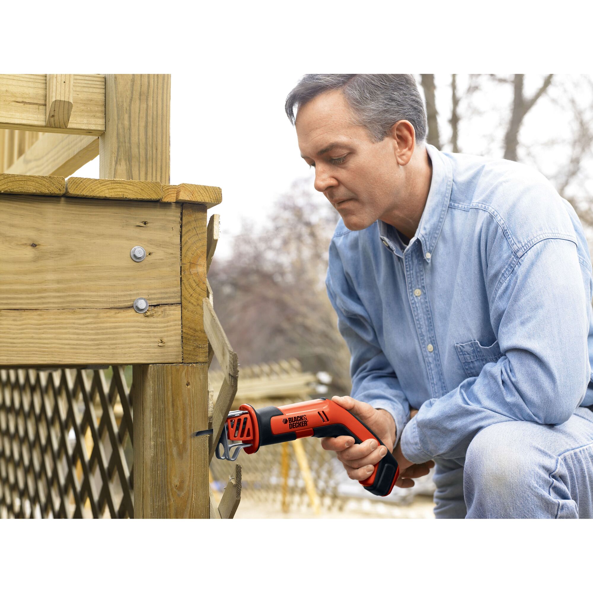 BLACKDECKER CHS6000 cordless reciprocating saw used for cutting wood outdoors.