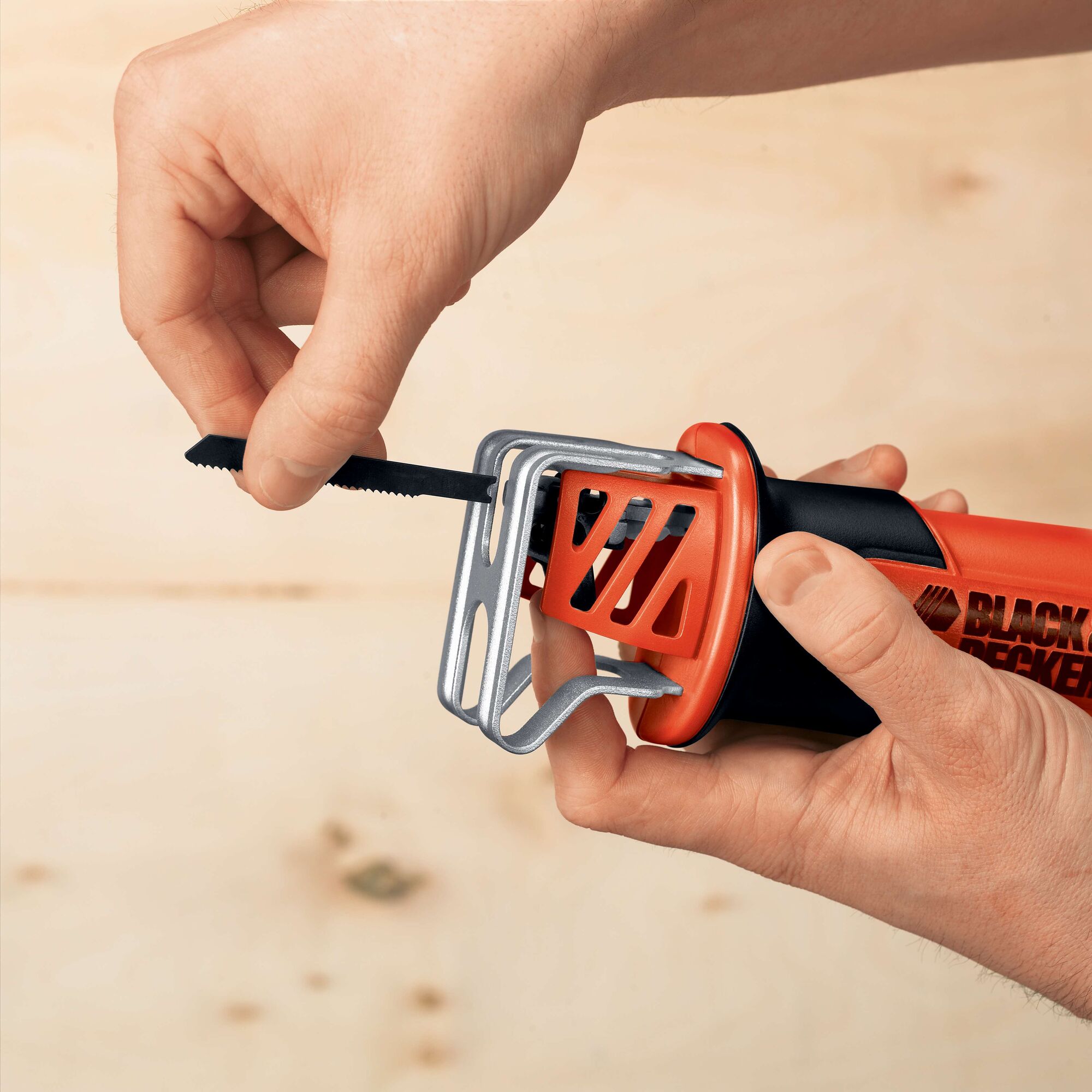 Photo of BLACKDECKER CHS6000 reciprocating saw blade being inserted, orange and black handle visible.