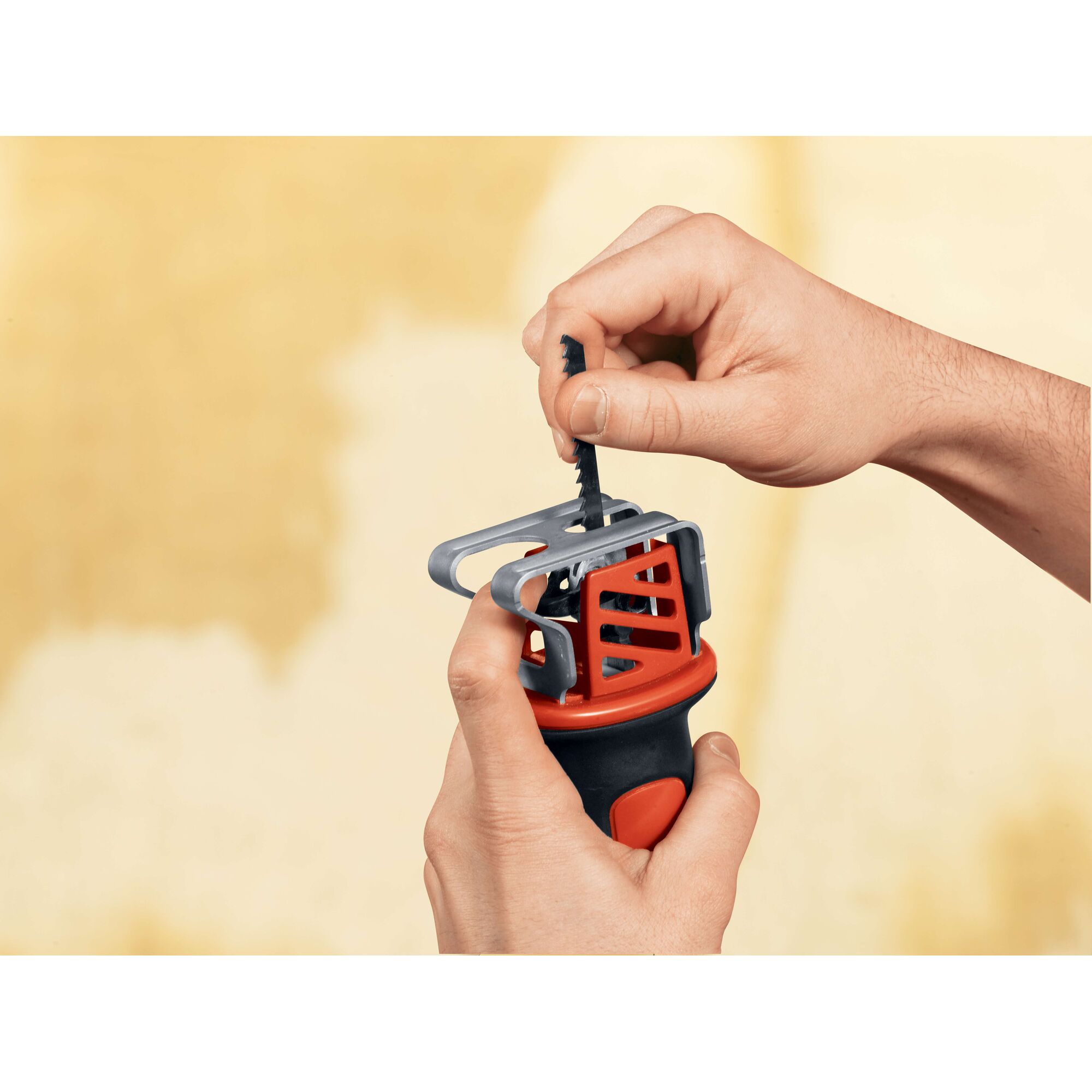 BLACKDECKER CHS6000 handheld saw blade installation, close-up view, red and black tool in hand.