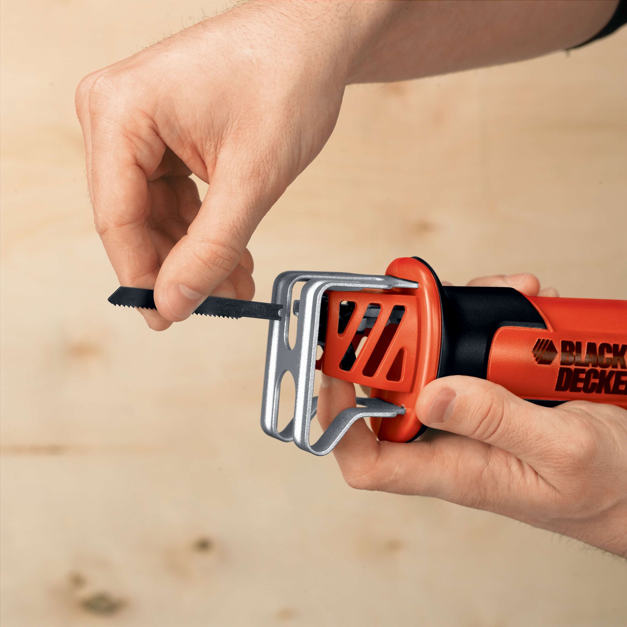 Photo of BLACKDECKER CHS6000 reciprocating saw being fitted with a blade, close-up on the handle and blade holder.