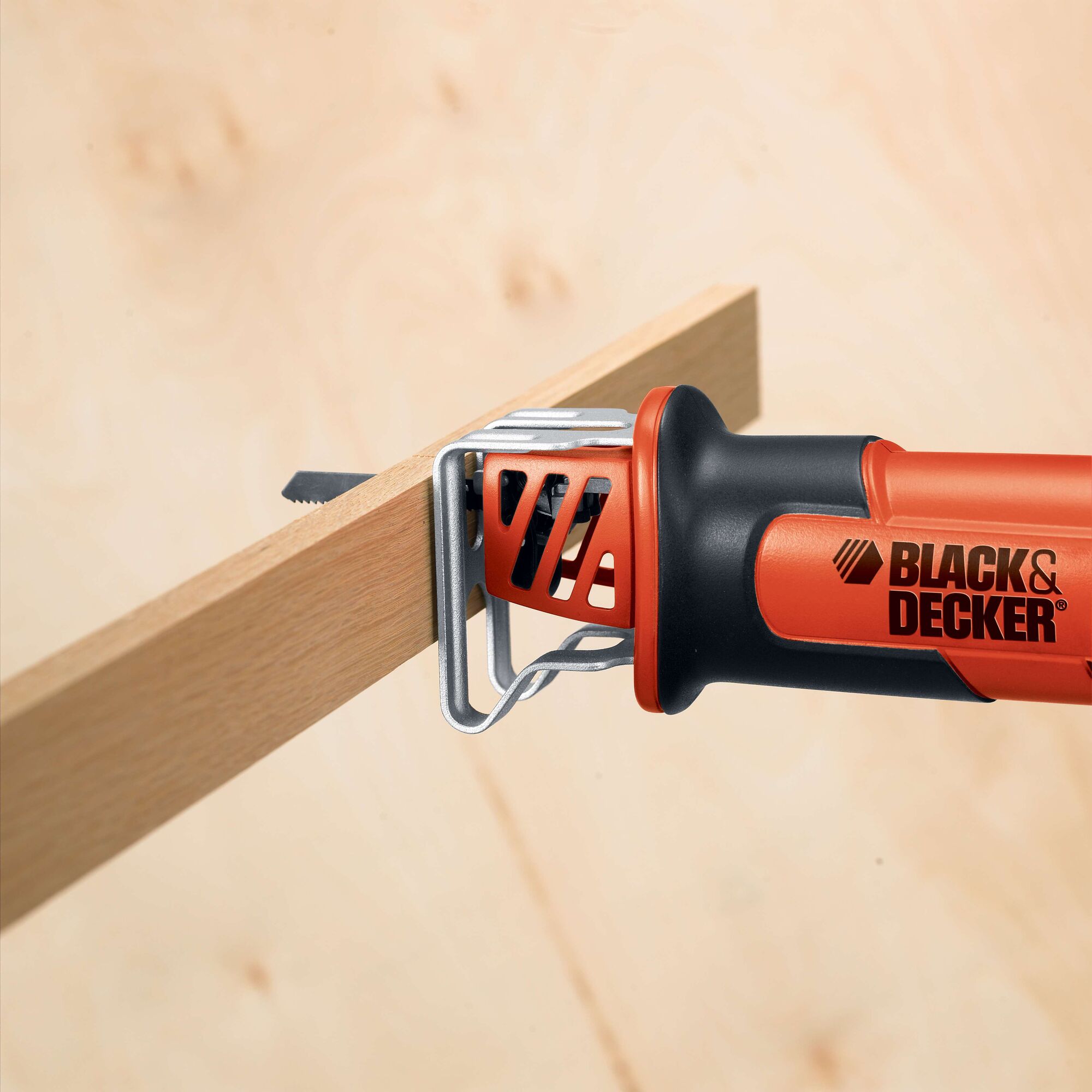 BLACK+DECKER CHS6000 reciprocating saw cutting wood, close-up side view.