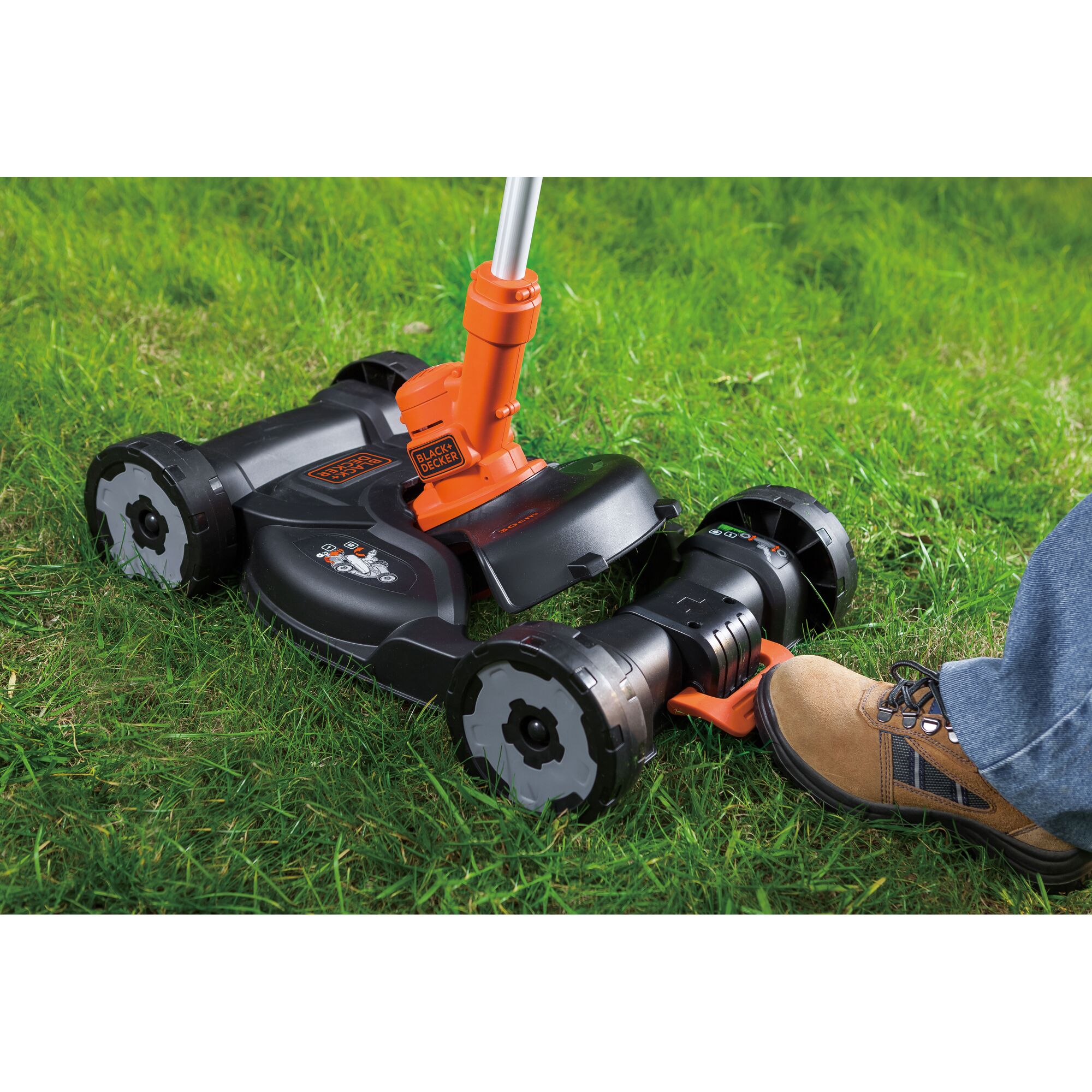 BLACKDECKER CM100N lawn mower attachment in action on grass, close-up side angle photography.