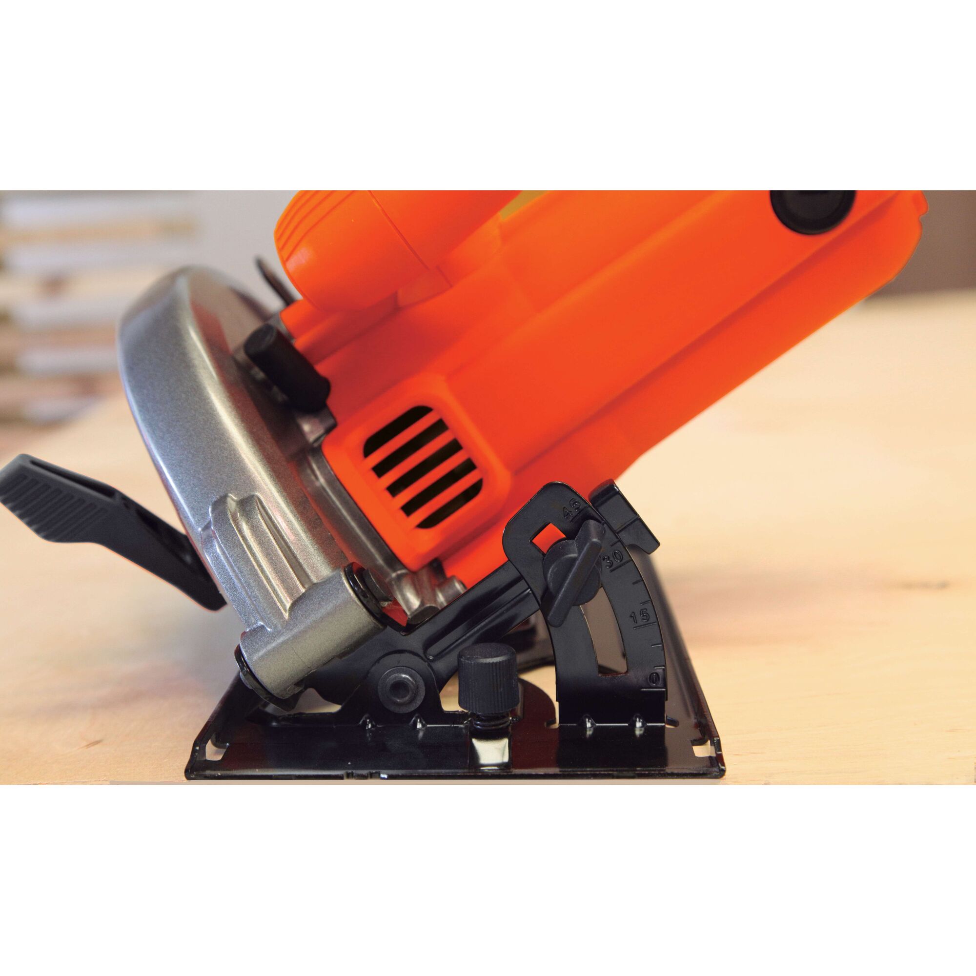 BLACKDECKER CS1004 circular saw side angle showing bevel adjustment and orange housing.
