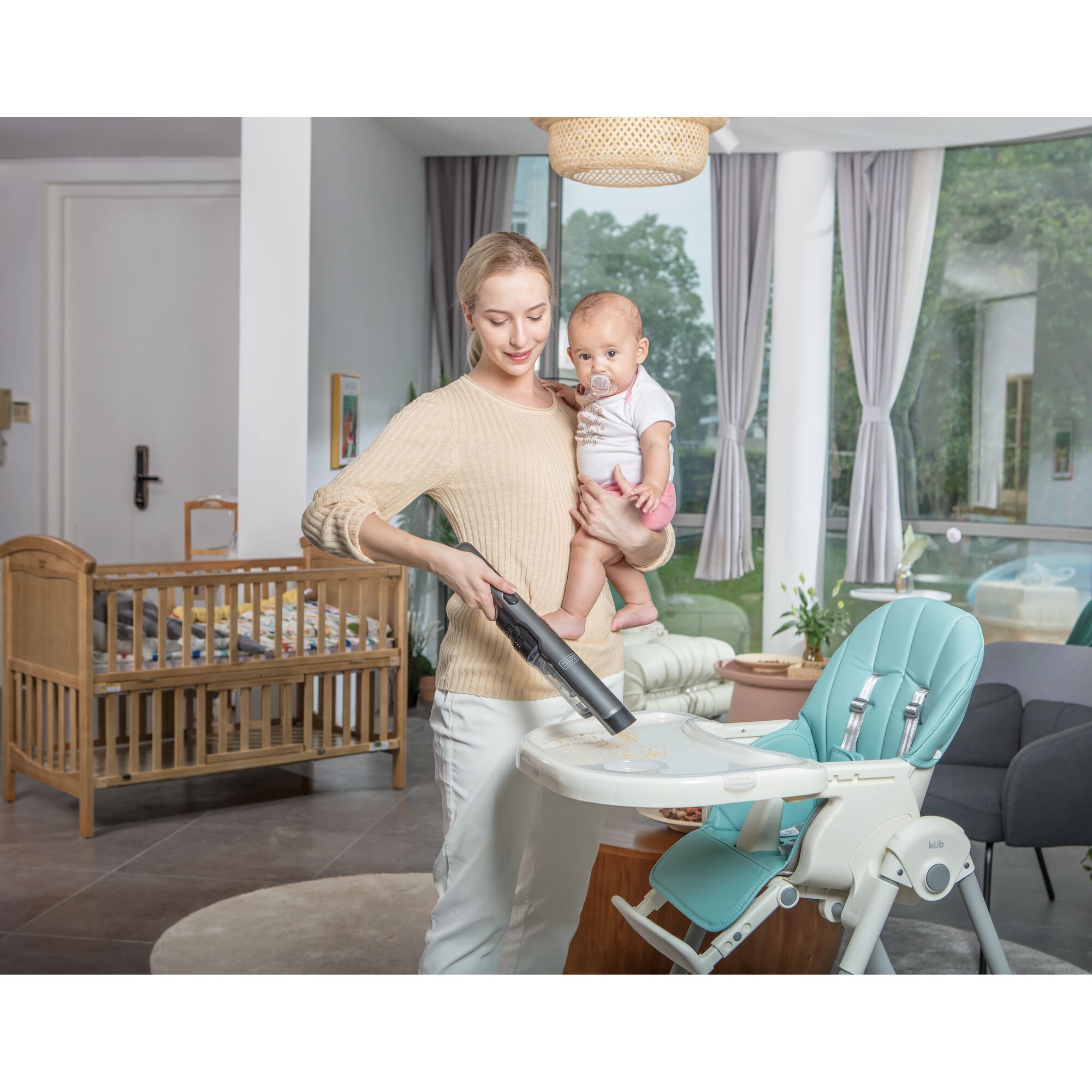 BLACKDECKER DVC320B01 handheld vacuum cleaning baby high chair tray in modern nursery room.