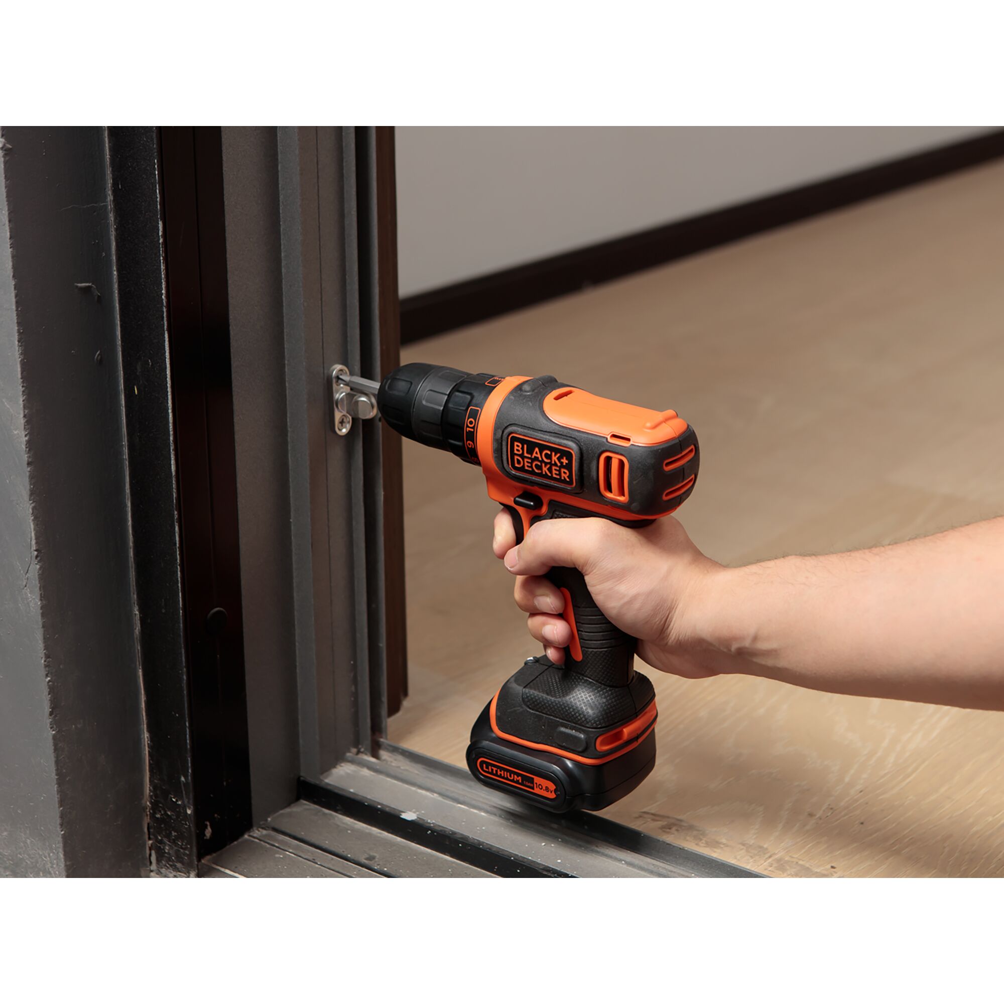BLACKDECKER EBDCDD12HS cordless drill being used to fasten a screw in a metal door frame.