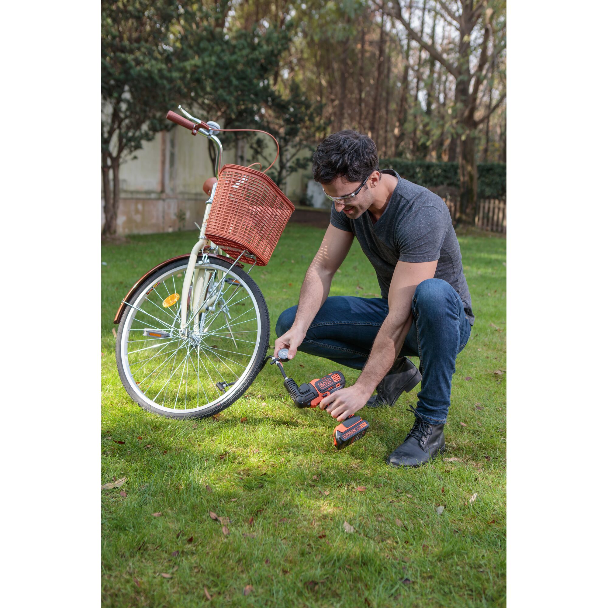 BLACKDECKER EIF183 cordless drill used for bicycle maintenance outdoors.