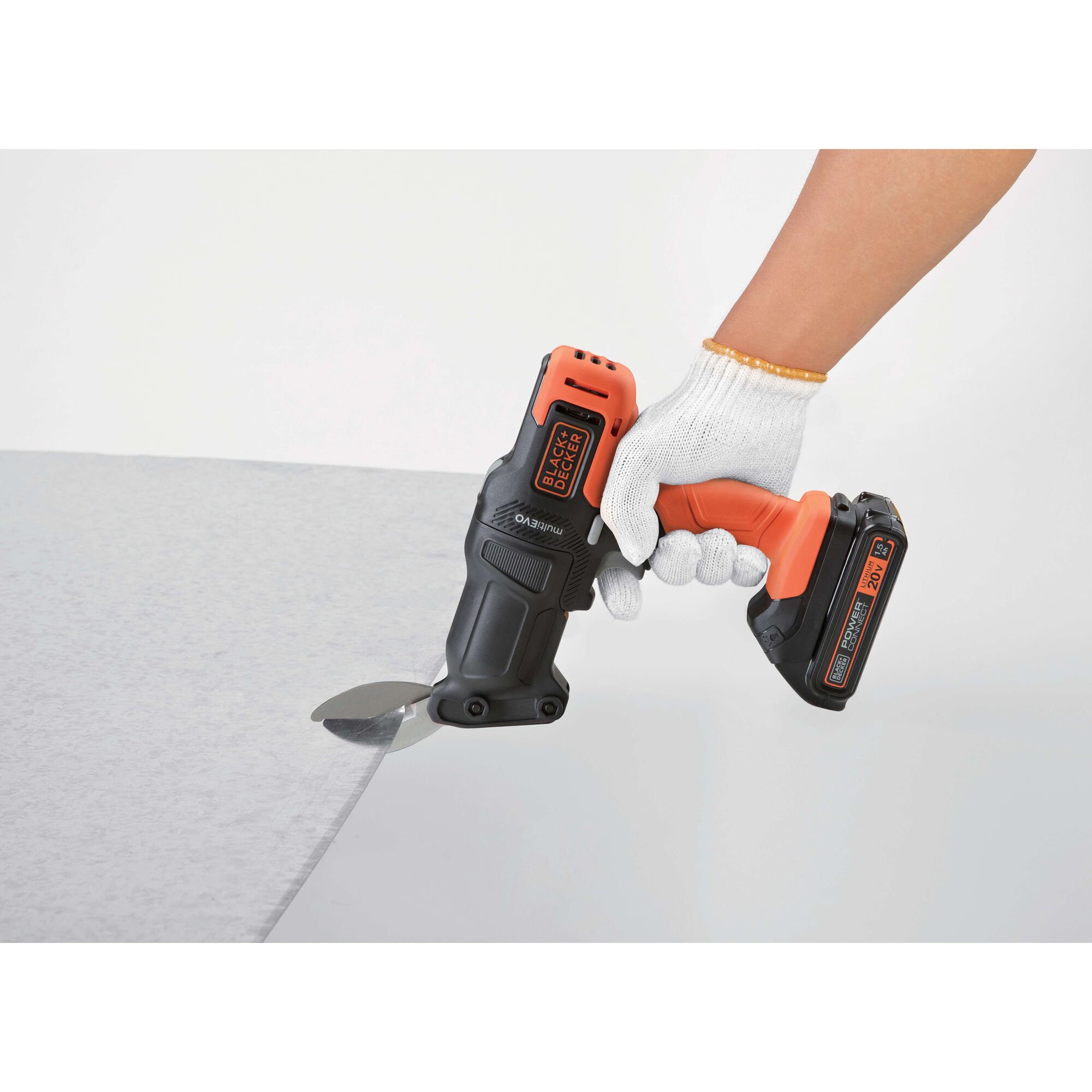 BLACKDECKER EMS183 cordless metal shear cutting sheet metal, side angle, gloved hand holding tool.