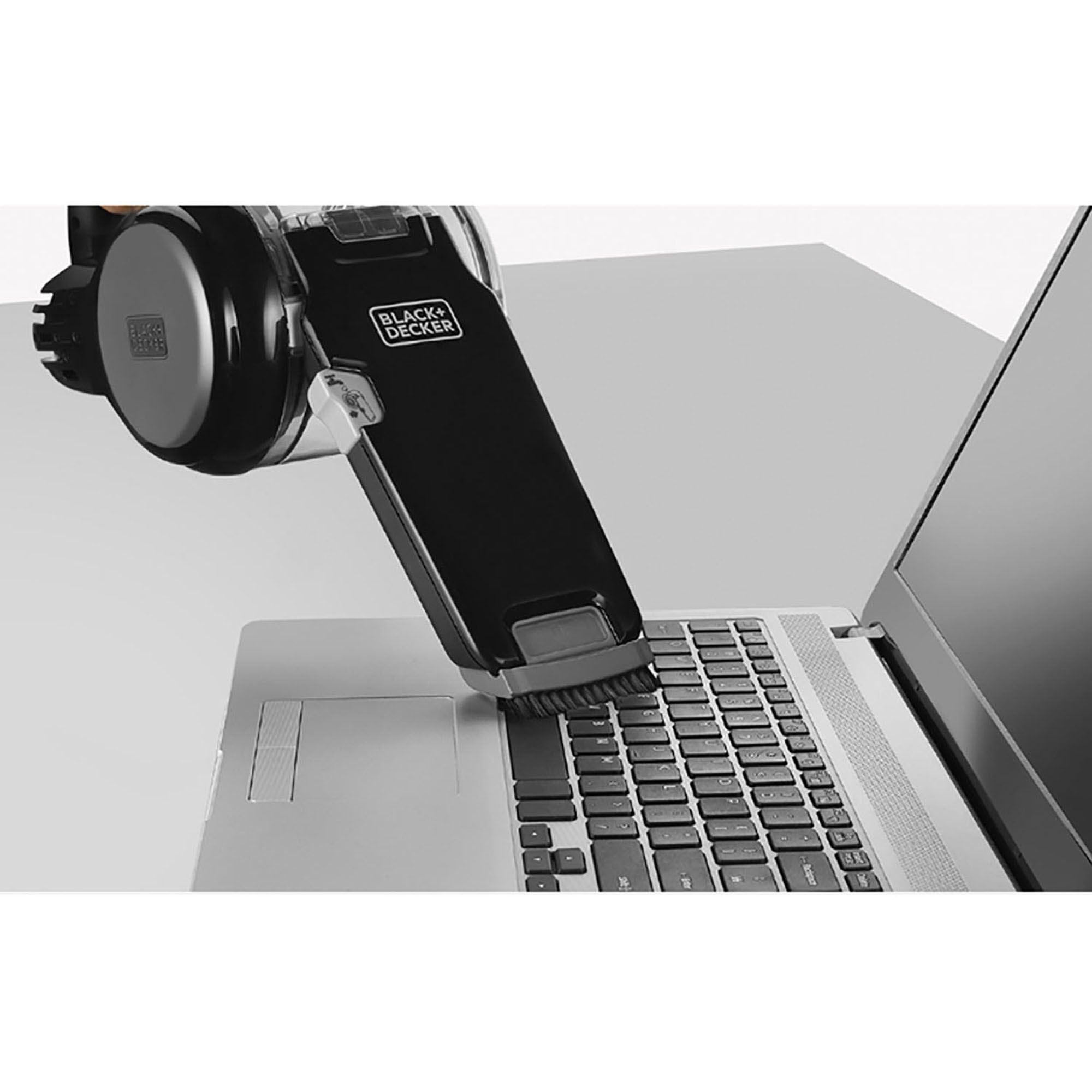 BLACKDECKER EPV1020BKA-KR handheld vacuum cleaning laptop keyboard, product photography, top view.