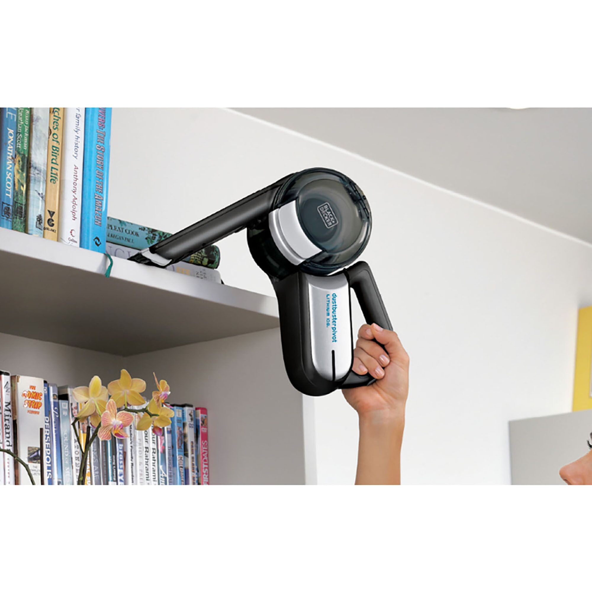BLACKDECKER handheld vacuum EPV1020BKA-KR cleaning a bookshelf in a modern living space.