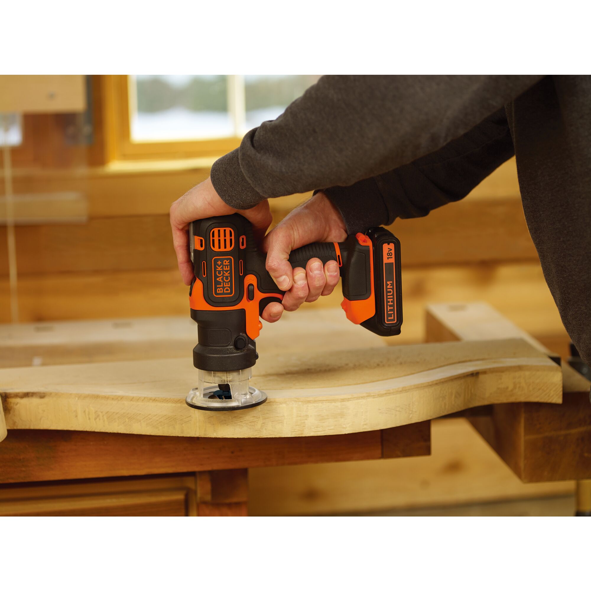 BLACKDECKER ERH183 cordless router in use on a wooden surface, close-up photography.