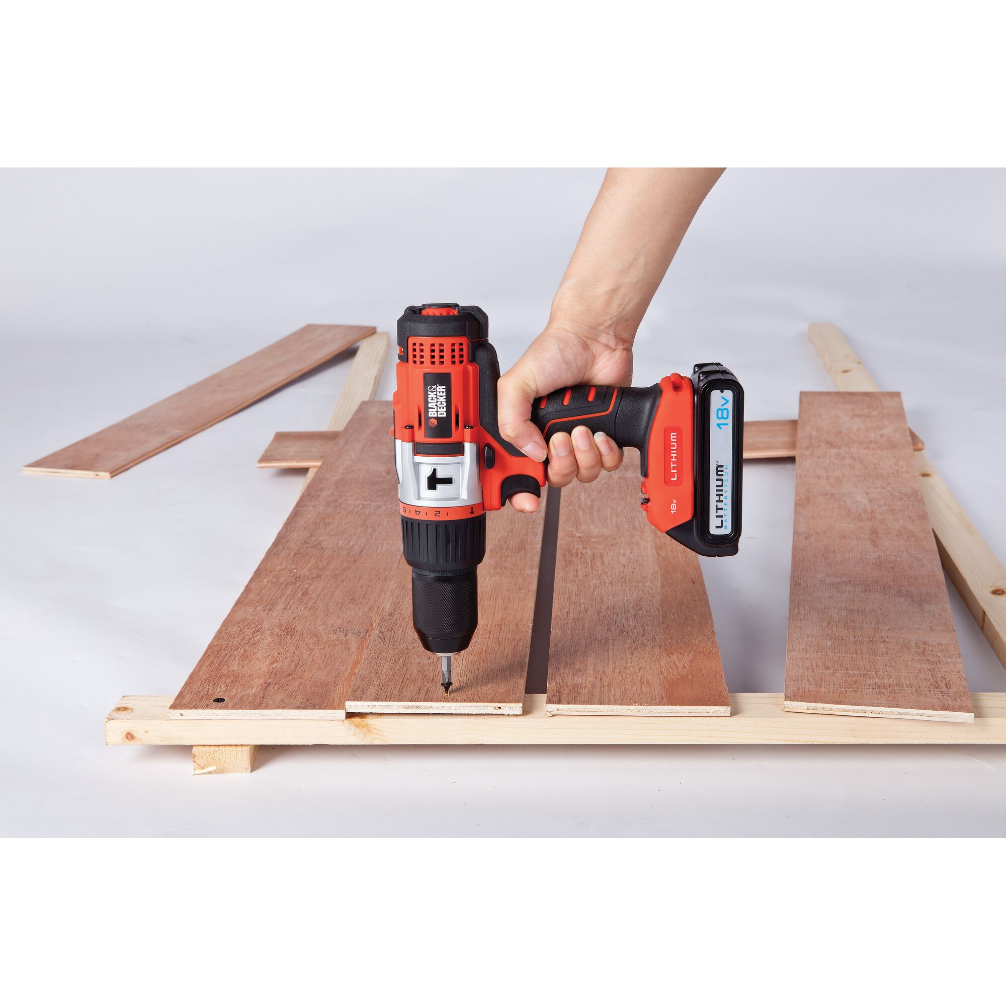 BLACKDECKER EXH18 cordless drill used to screw wood panels, close-up angle, product in hand.