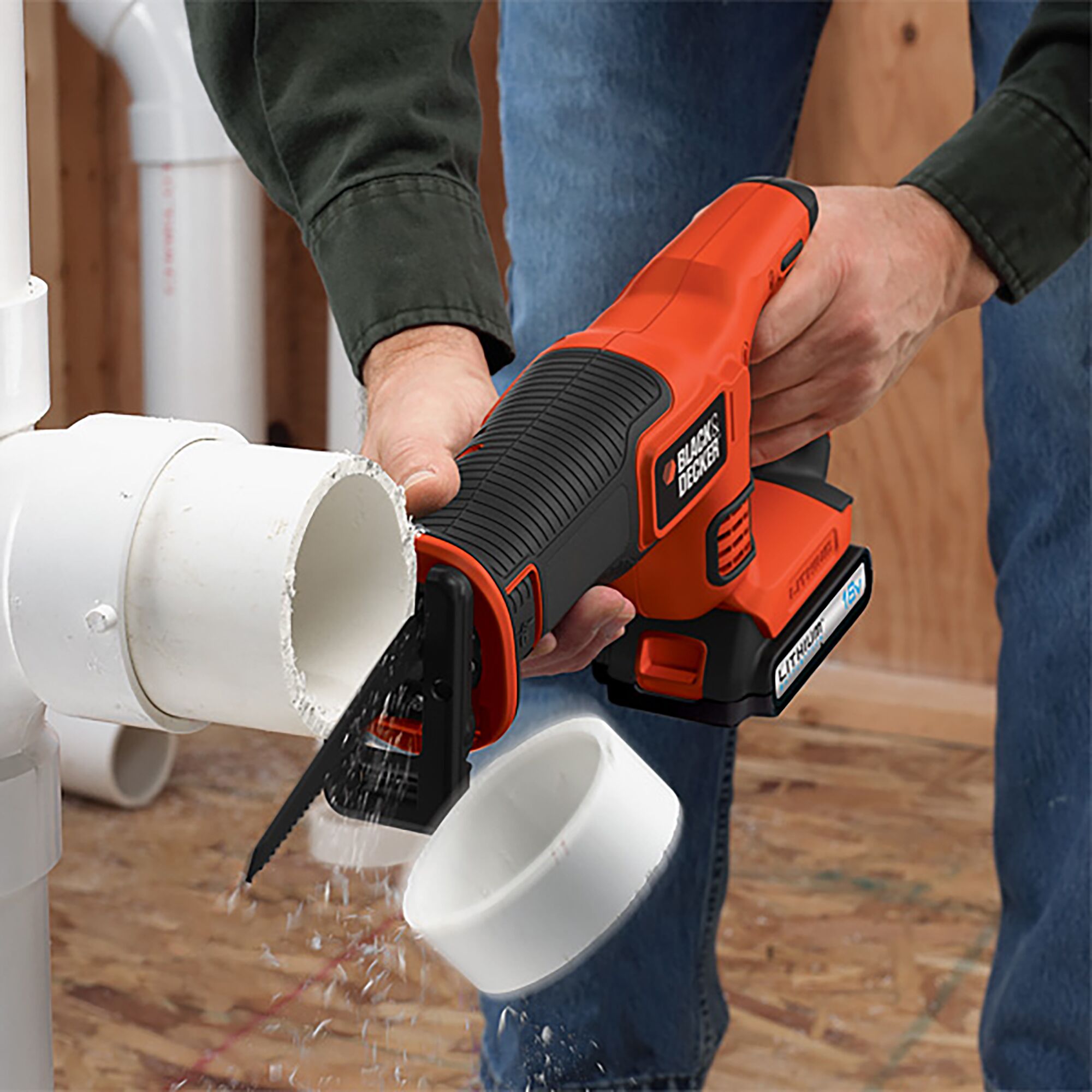BLACKDECKER EXR18 cordless reciprocating saw cutting white PVC pipe indoors.