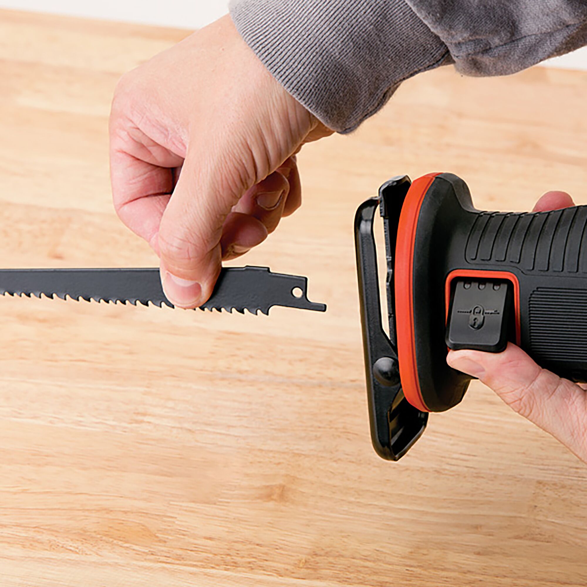 BLACKDECKER EXR18 reciprocating saw blade installation on wood table, close-up angle.