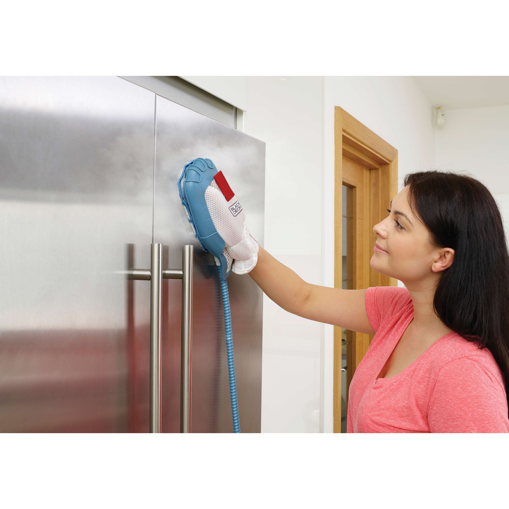 BLACKDECKER FSH10SM steam cleaning glove in use on stainless steel refrigerator door.
