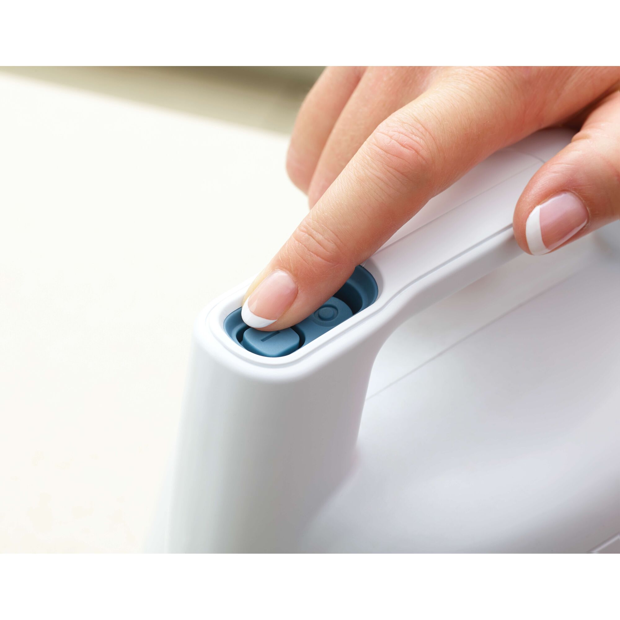 BLACKDECKER FSH10SM white handheld device, blue button detail, product category photography, closeup view.