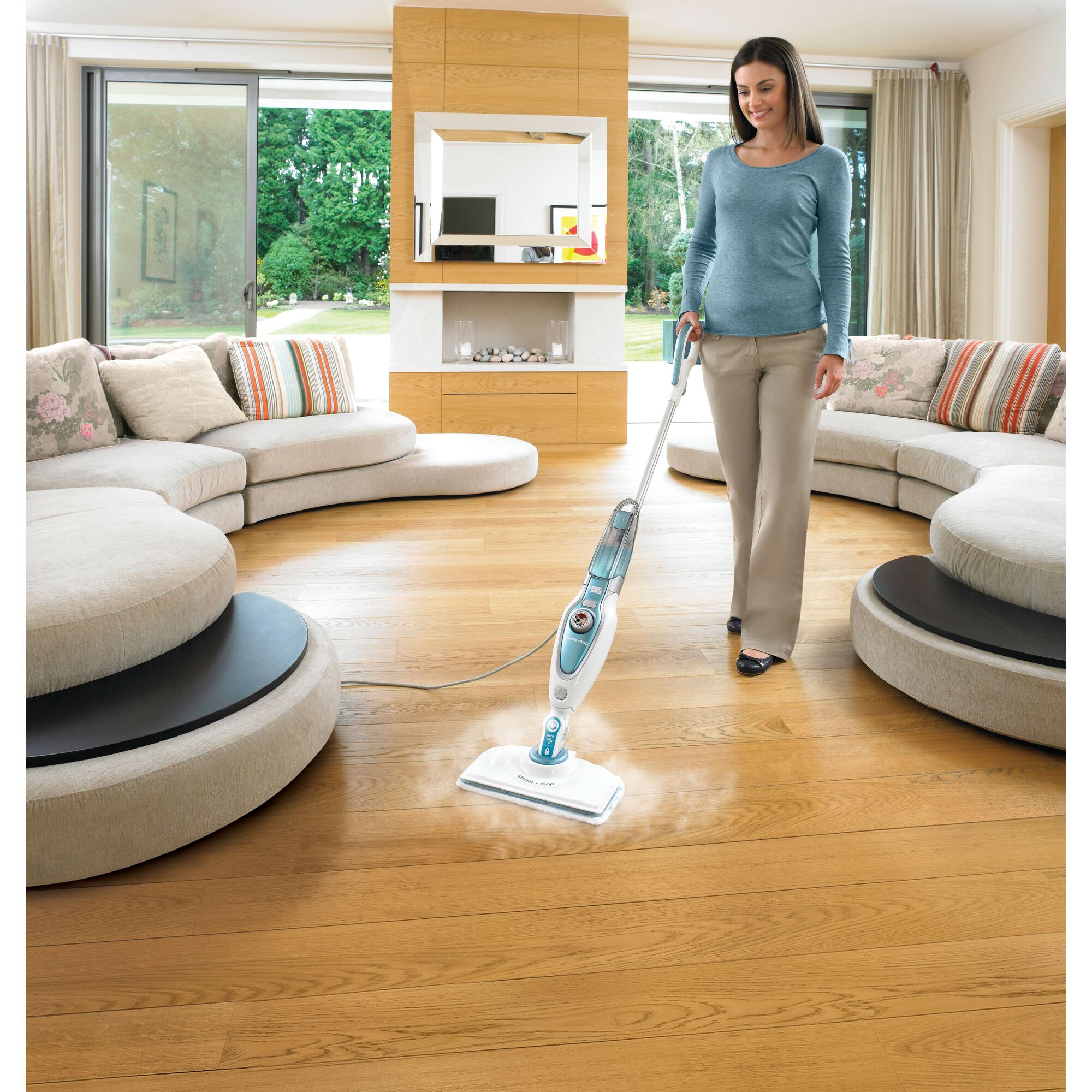 BLACKDECKER FSM1620 steam mop cleaning wood floor in modern living room, front angle.