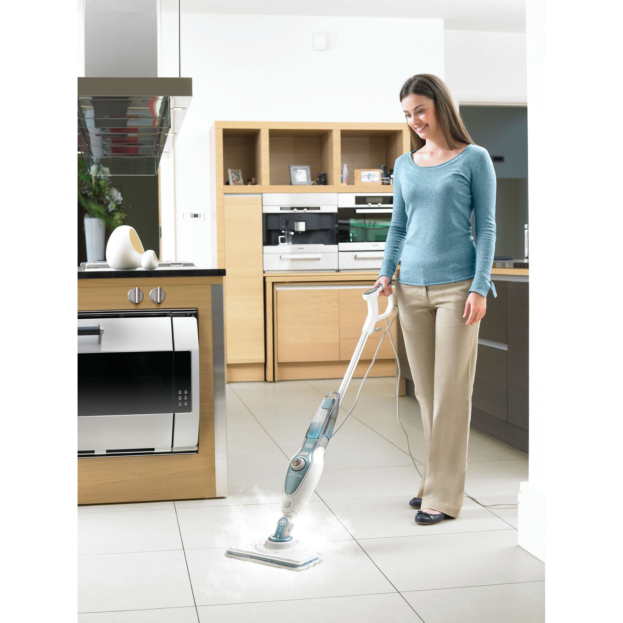 BLACKDECKER FSM1620 steam mop cleaning tile floor in modern kitchen, handheld view.