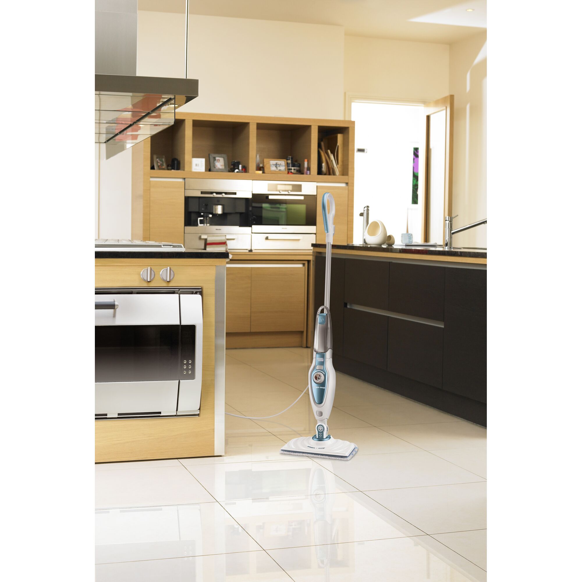 BLACKDECKER FSM1620 steam mop in modern kitchen, white and blue finish, upright on tiled floor.