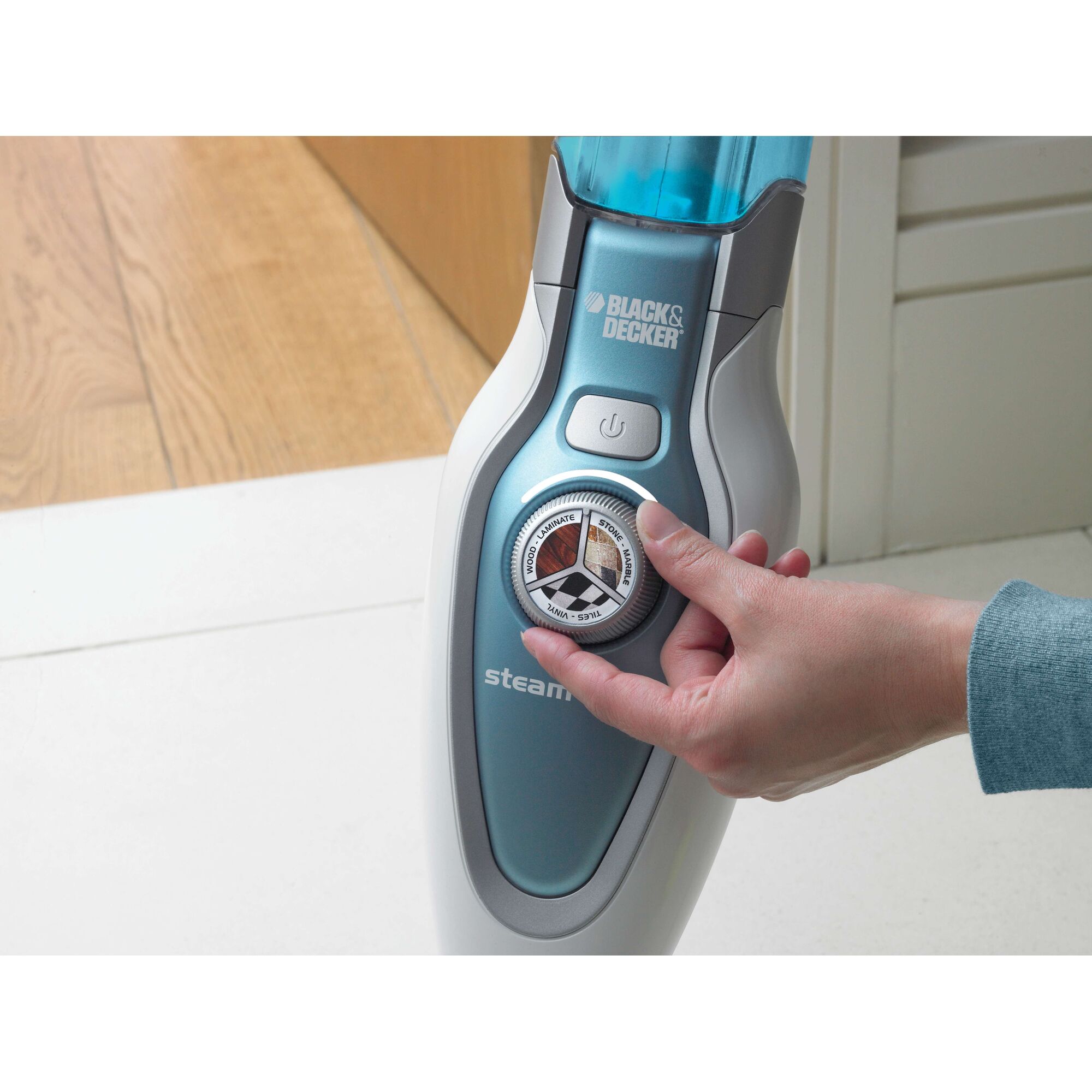BLACKDECKER FSM1620 steam mop control dial being adjusted by hand, close-up front view.