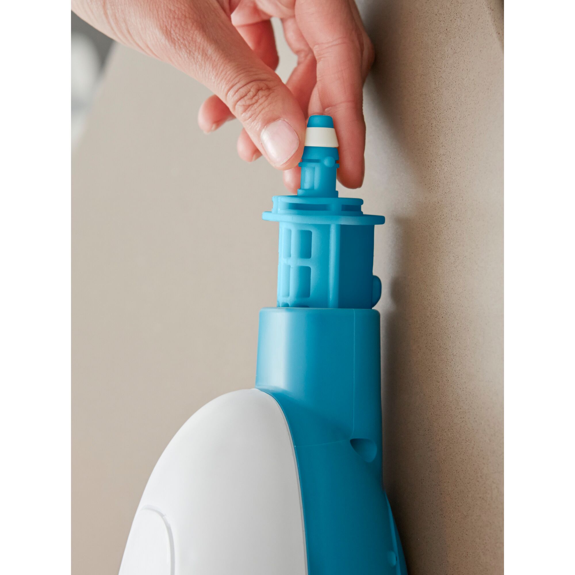 BLACKDECKER FSMH13E5 steam mop water tank nozzle close-up held by hand.