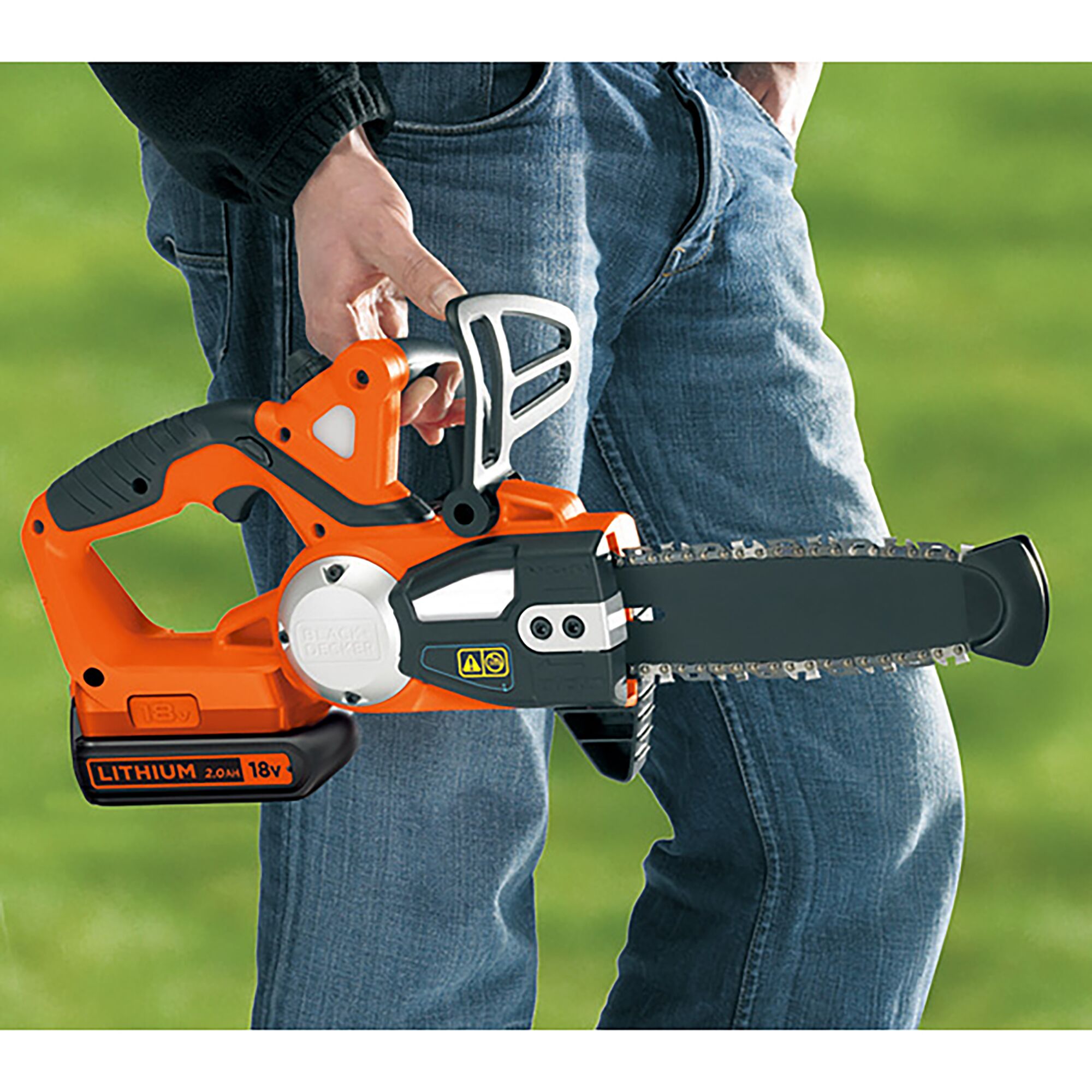 BLACKDECKER GKC1820LBN cordless 18V chainsaw, orange and black, held by person outdoors.