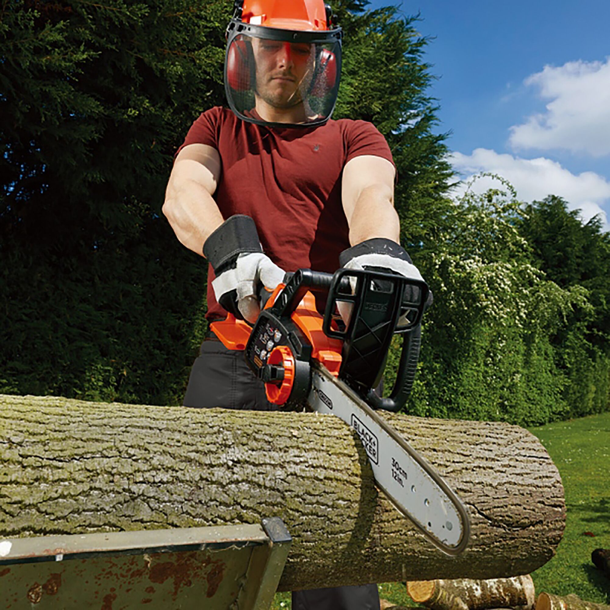 BLACKDECKER GKC3630L chainsaw cutting log outdoors, user with safety gear, product category photography.
