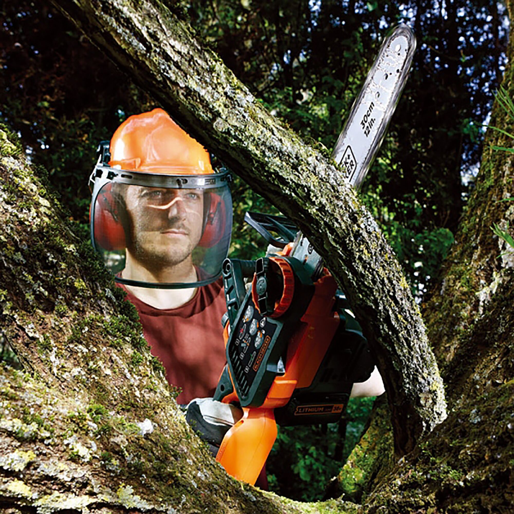 BLACKDECKER GKC3630L cordless chainsaw in use cutting tree branches outdoors.