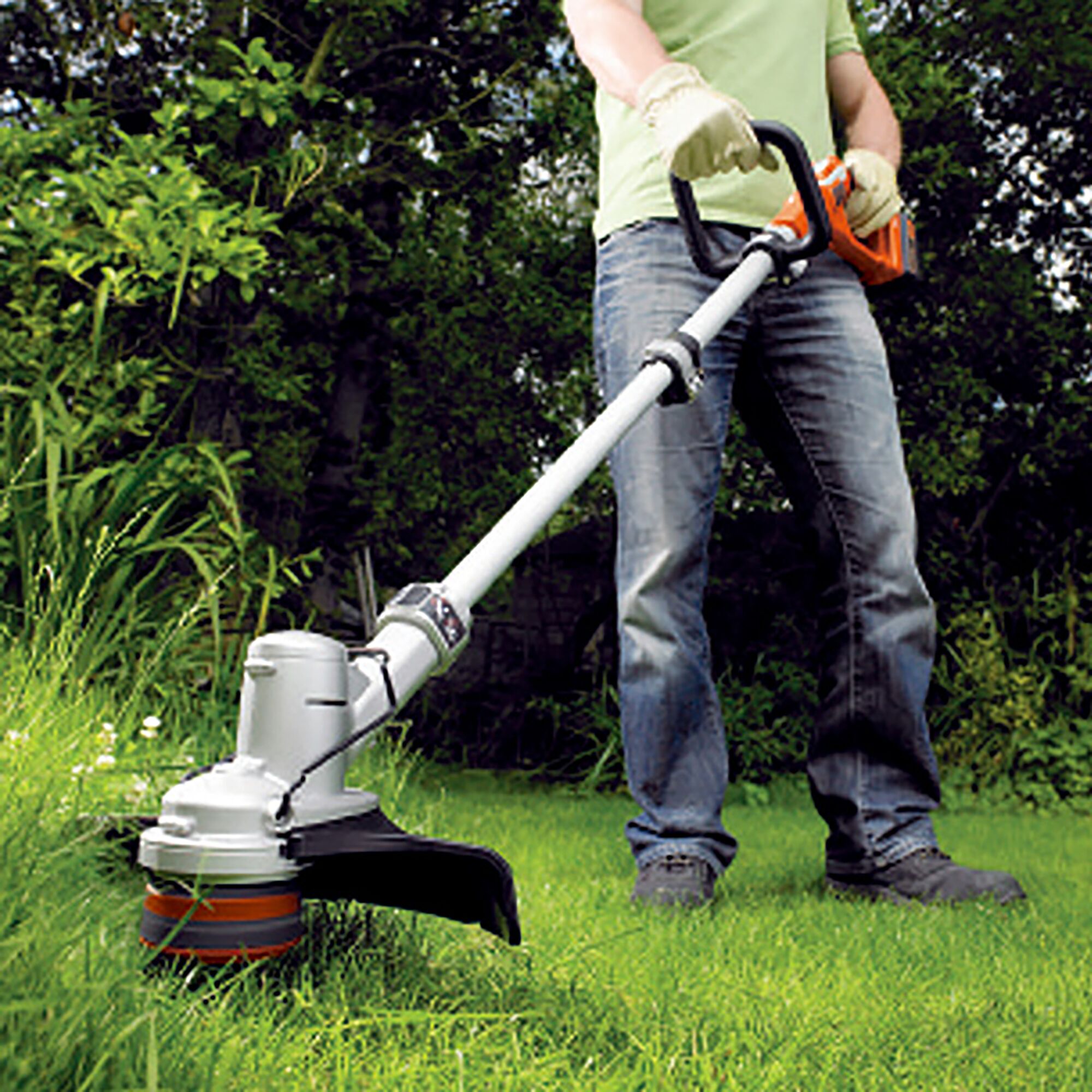 Photo of BLACKDECKER GLC36N grass trimmer in use, cutting grass in a garden setting.