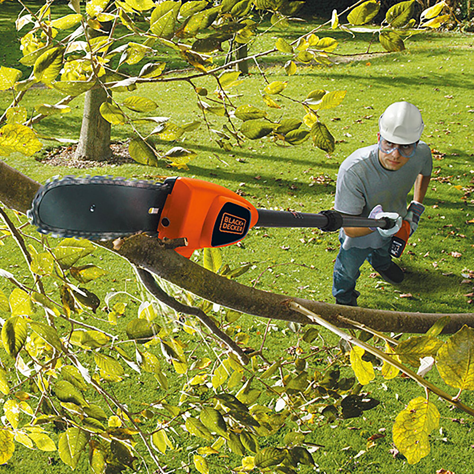 BLACK+DECKER GPC1820LBN pole chainsaw trimming tree branches outdoors.