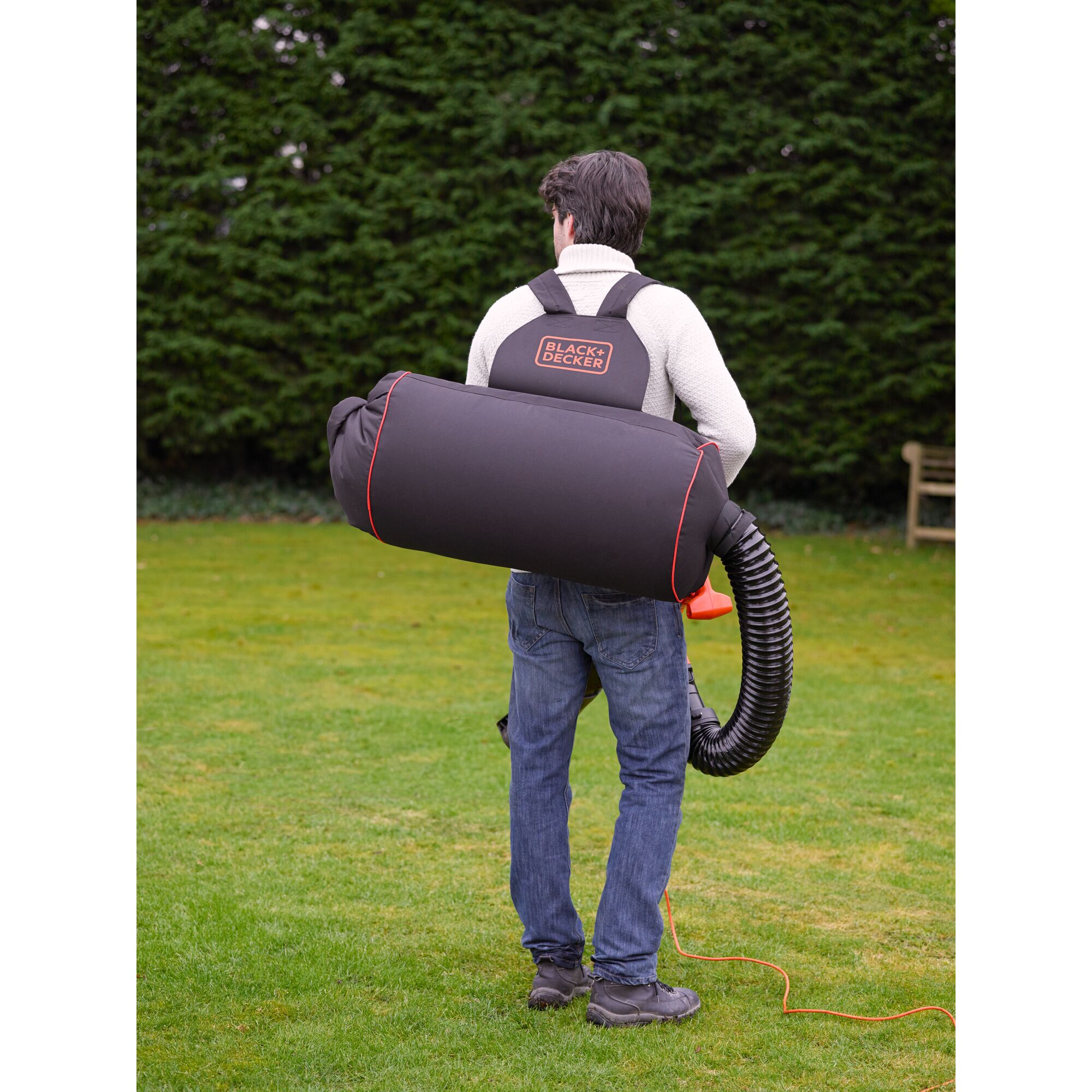 Photo of BLACK+DECKER GW3031BP garden vacuum and blower worn as a backpack, outdoor view, rear angle.