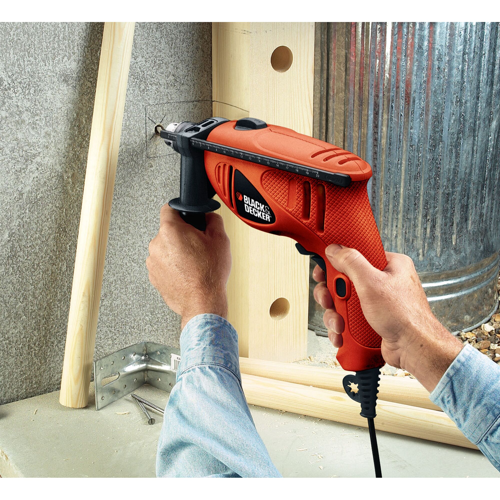 Photo of BLACKDECKER HD450 electric drill in use on concrete wall, orange and black design, photography category.