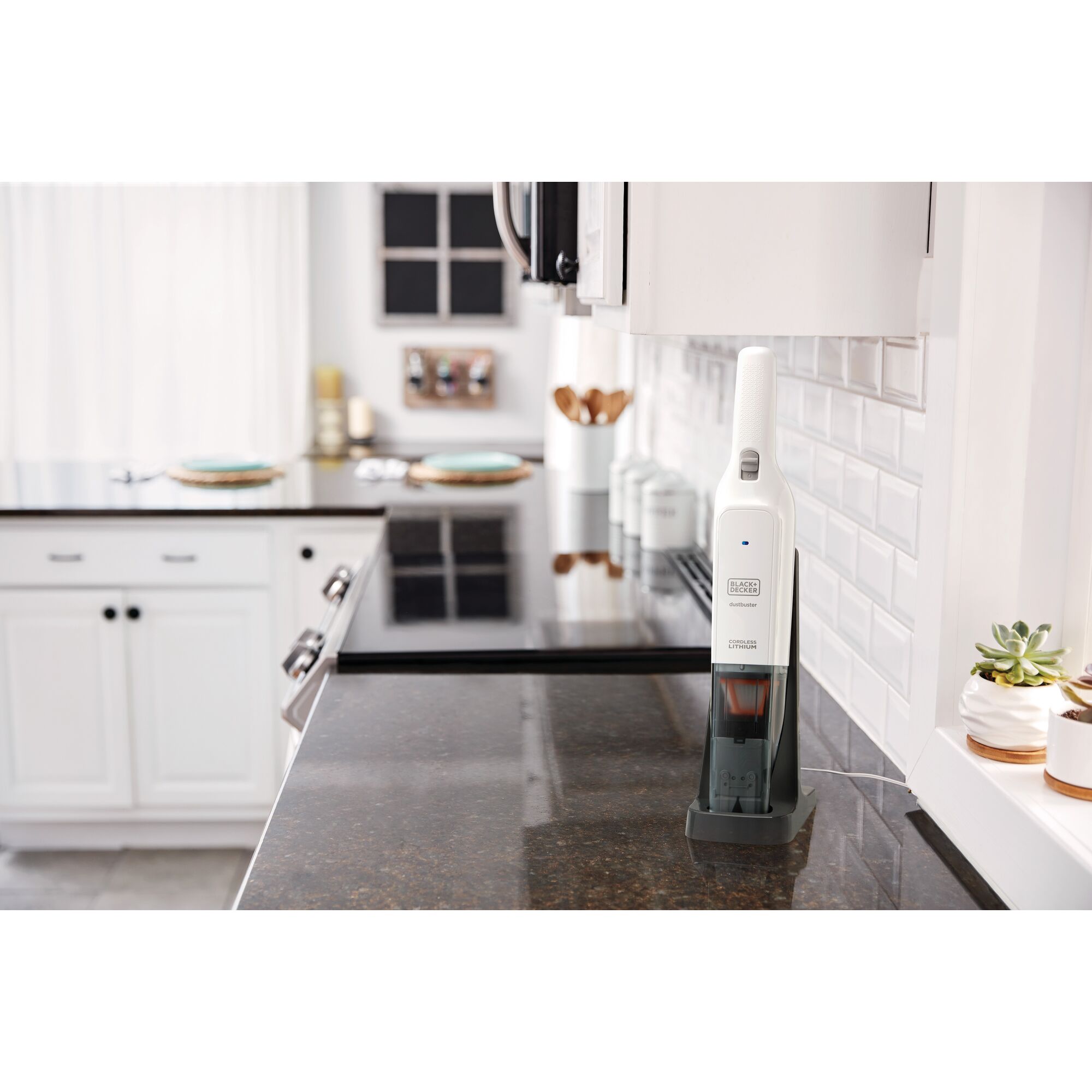 Photo of BLACKDECKER HLVC315B handheld vacuum cleaner in charging base on kitchen countertop.