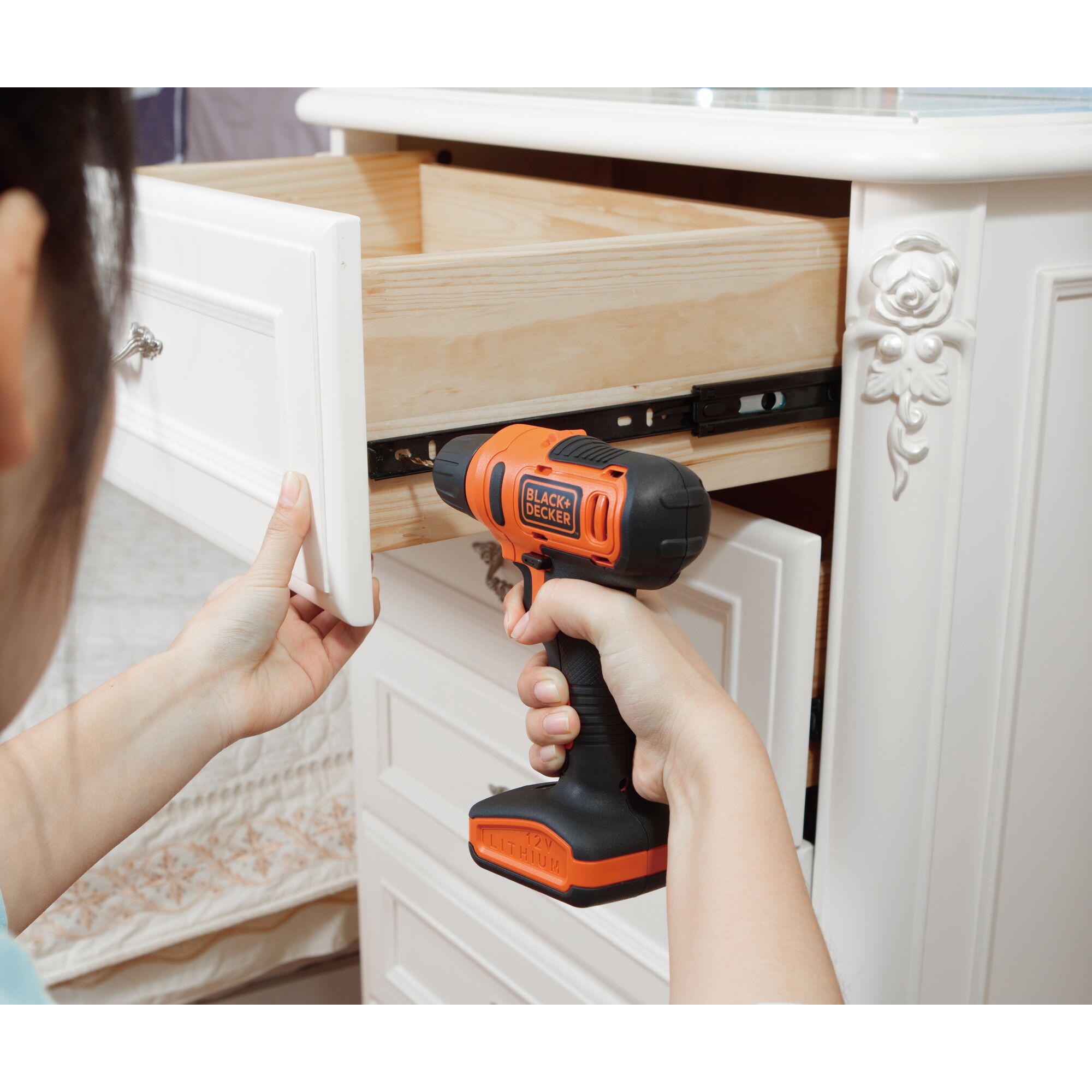 Photo of BLACKDECKER LD12SM-A9 cordless drill used to fix a white drawer in a home setting.