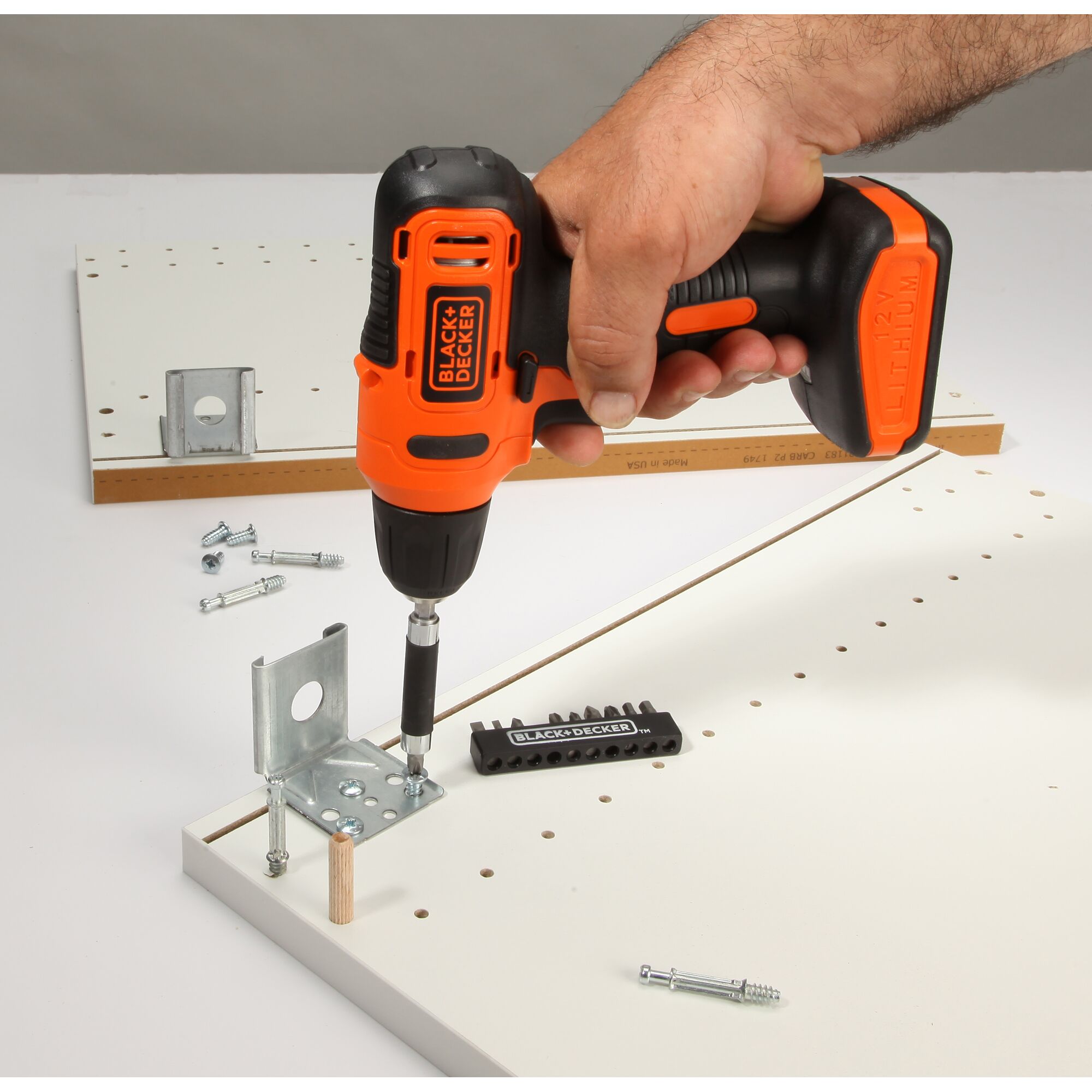 Photo of BLACKDECKER LD12SP cordless drill used to assemble furniture with metal brackets and screws.