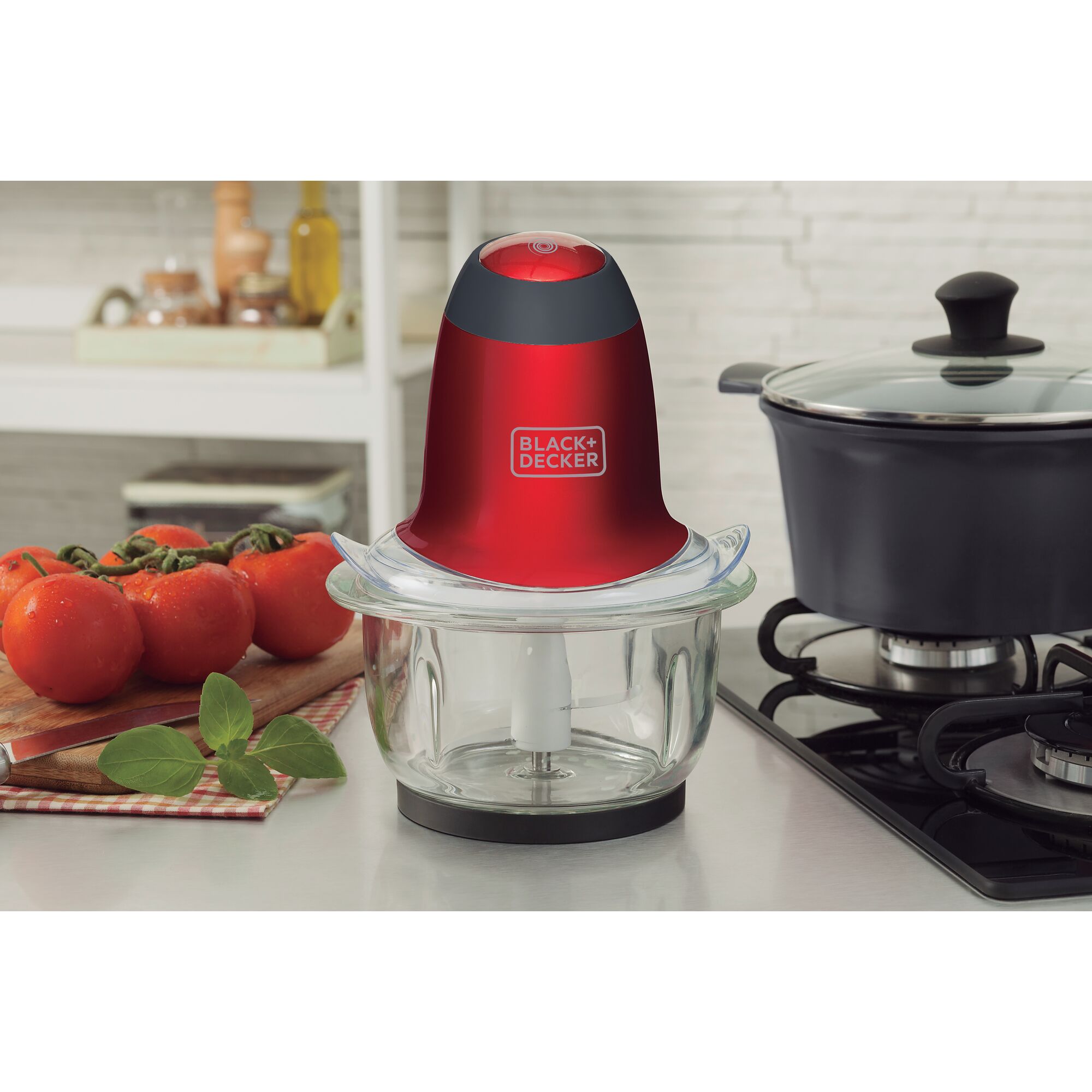 BLACKDECKER MP200V red food chopper on kitchen counter next to tomatoes and stove.