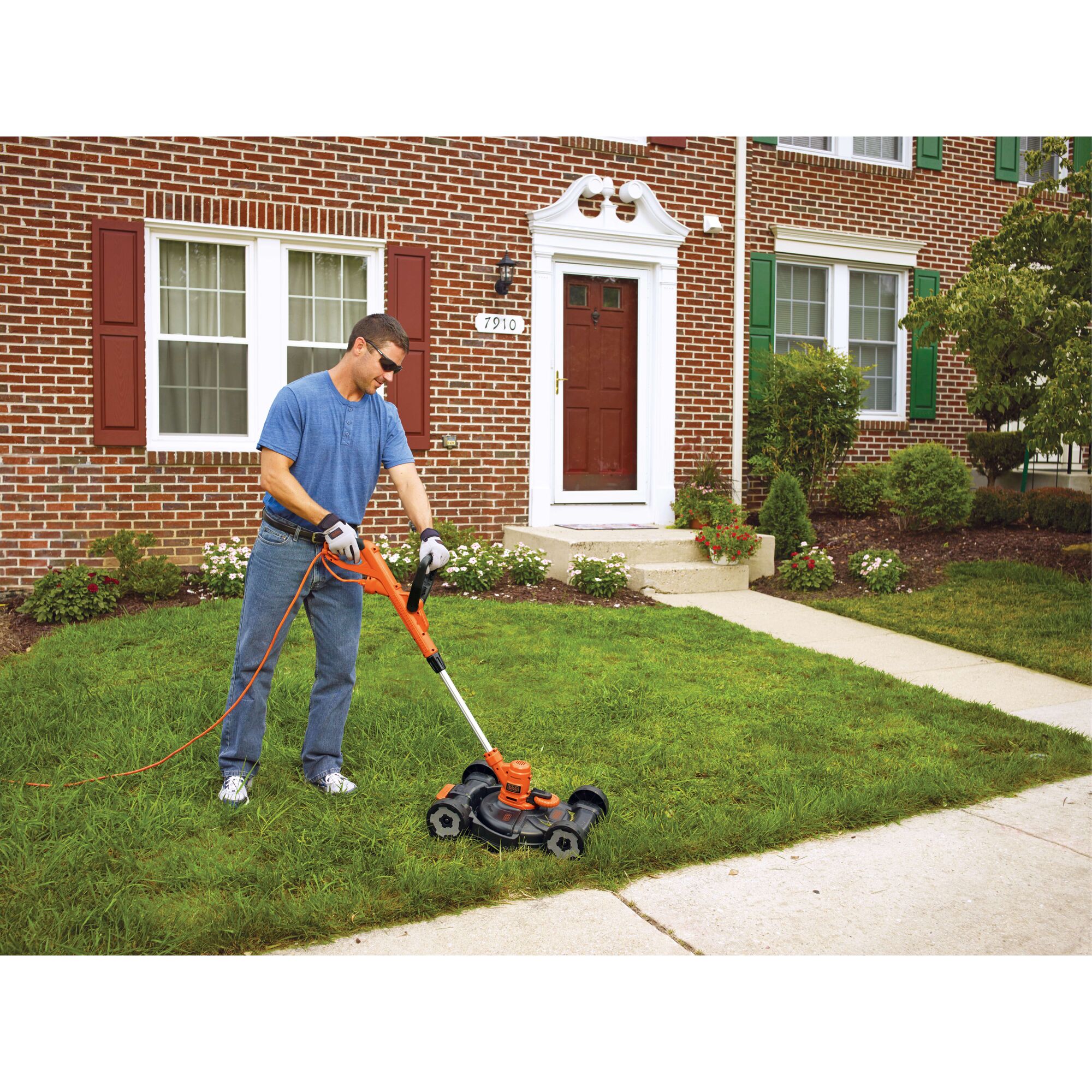 BLACKDECKER MTE912 lawn mower and trimmer in use on a residential lawn, orange and black design.