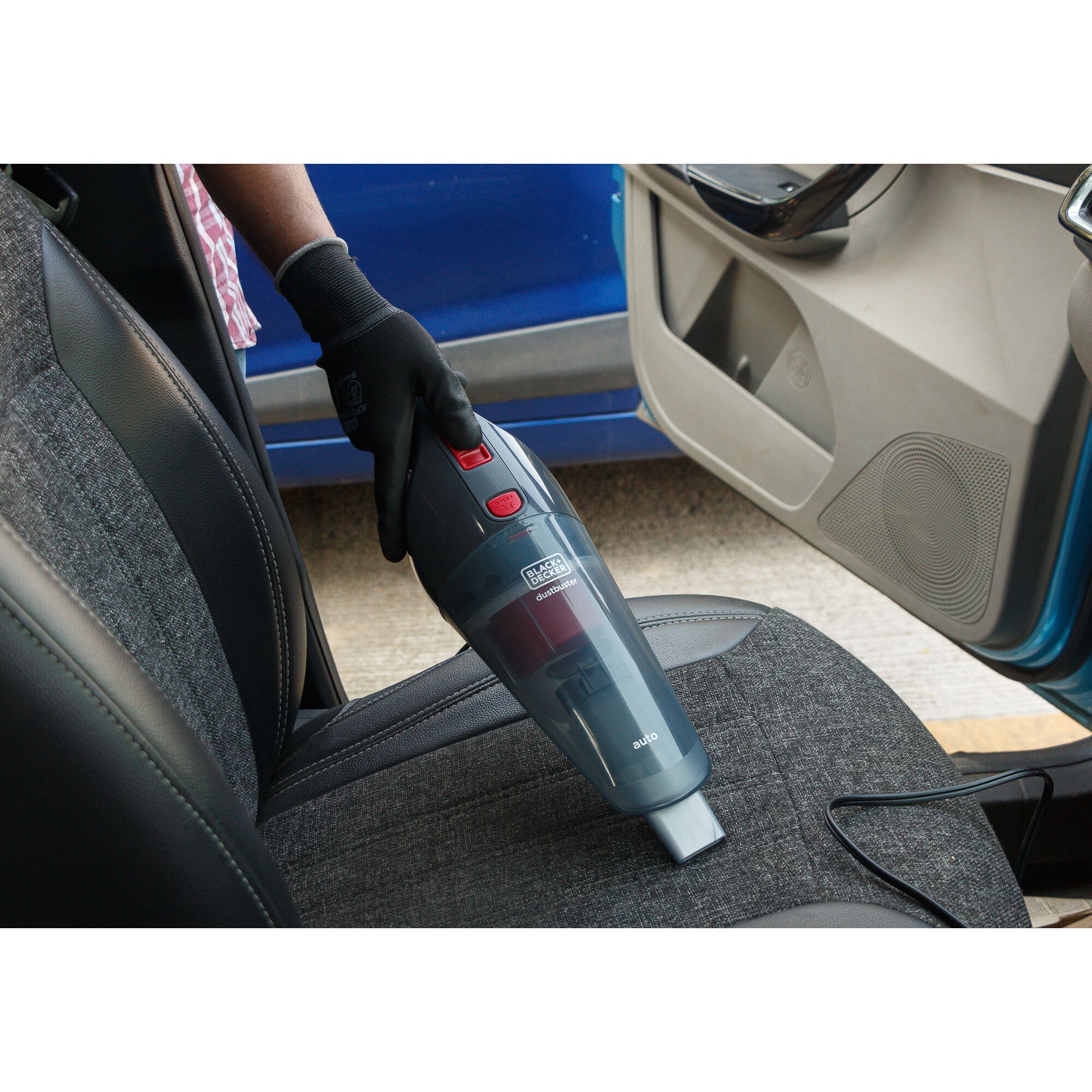 BLACKDECKER NV1200AV handheld vacuum cleaner used on car seat, close-up view.