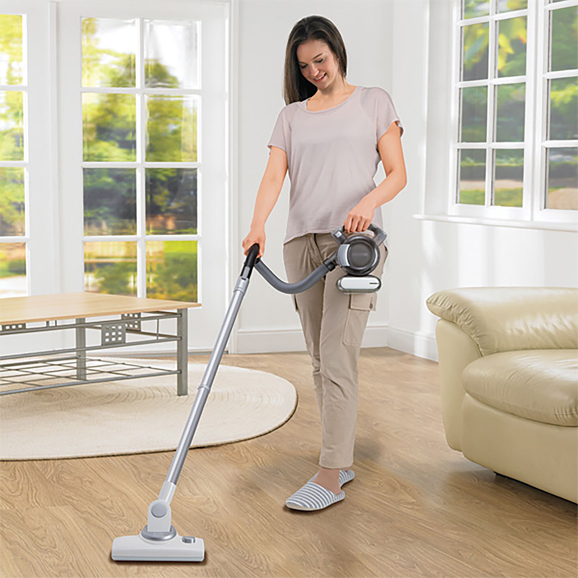 BLACKDECKER PD1810LI cordless vacuum cleaner in use on hardwood floor in living room.