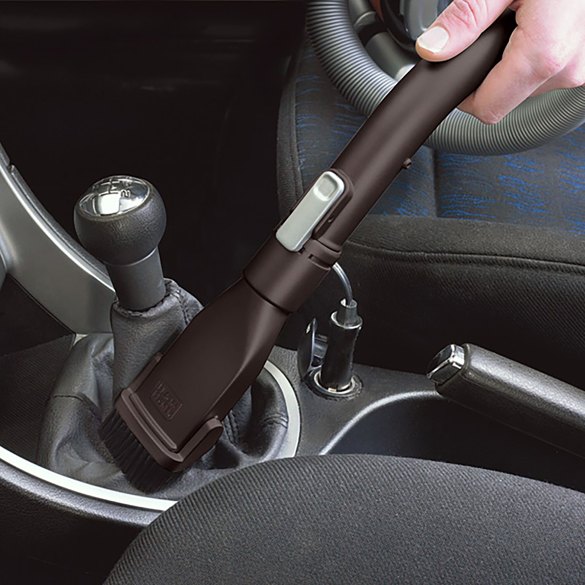 BLACKDECKER PD1810LI handheld vacuum cleaning car interior with nozzle attachment.