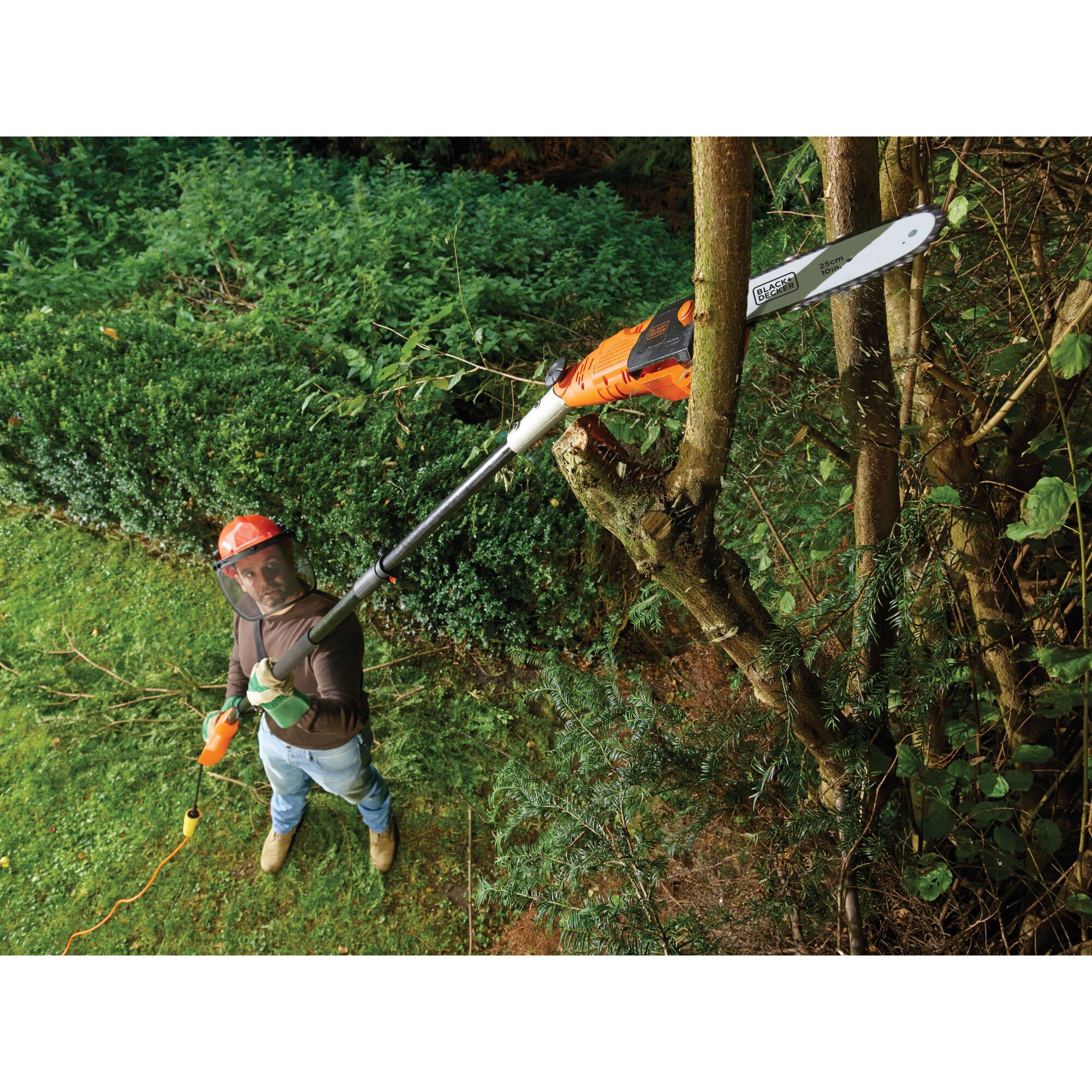 BLACKDECKER PS7525 pole saw used for pruning branches in a garden, orange and black design.