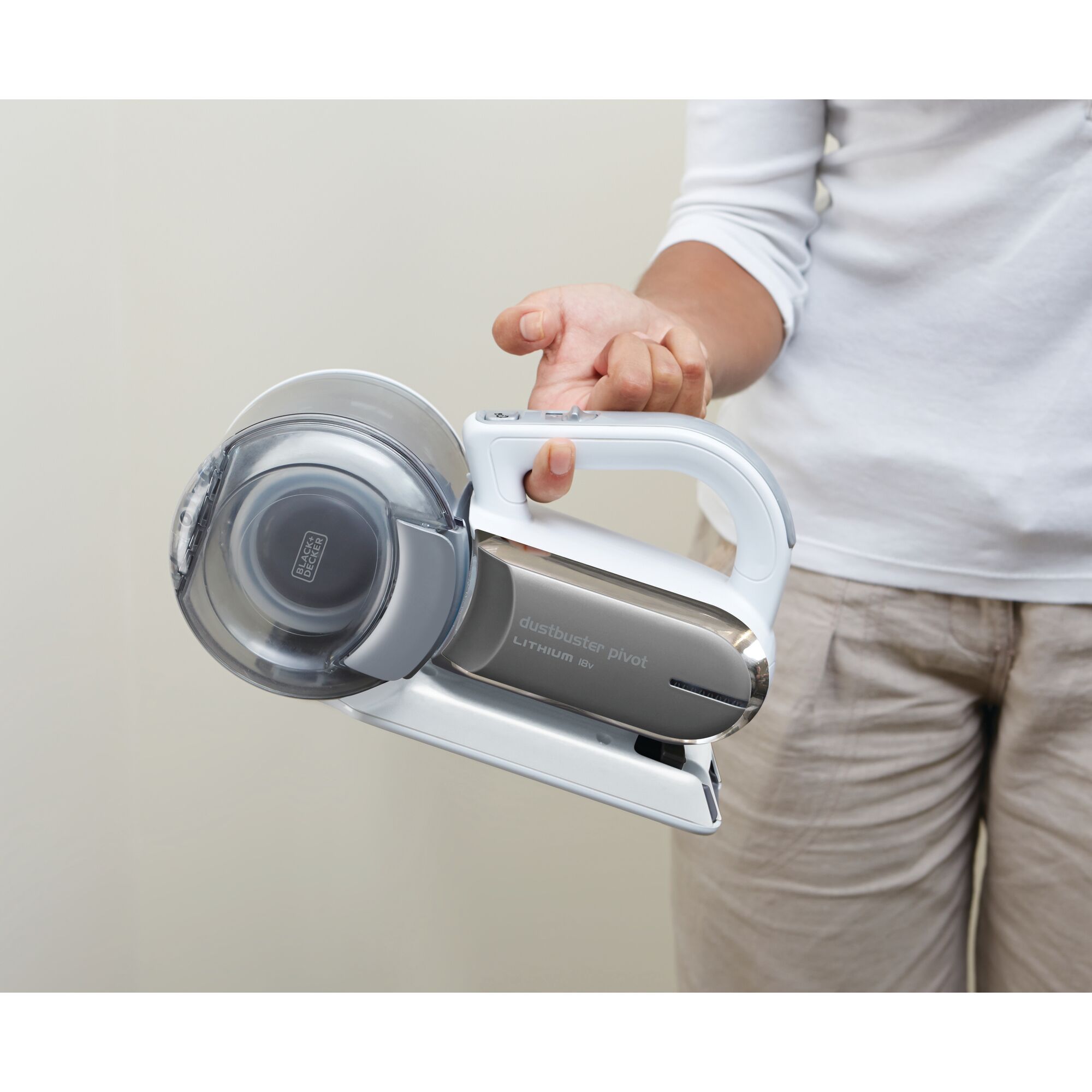 Photo of BLACKDECKER PV1020CAC handheld vacuum cleaner being held by a person in casual clothing.