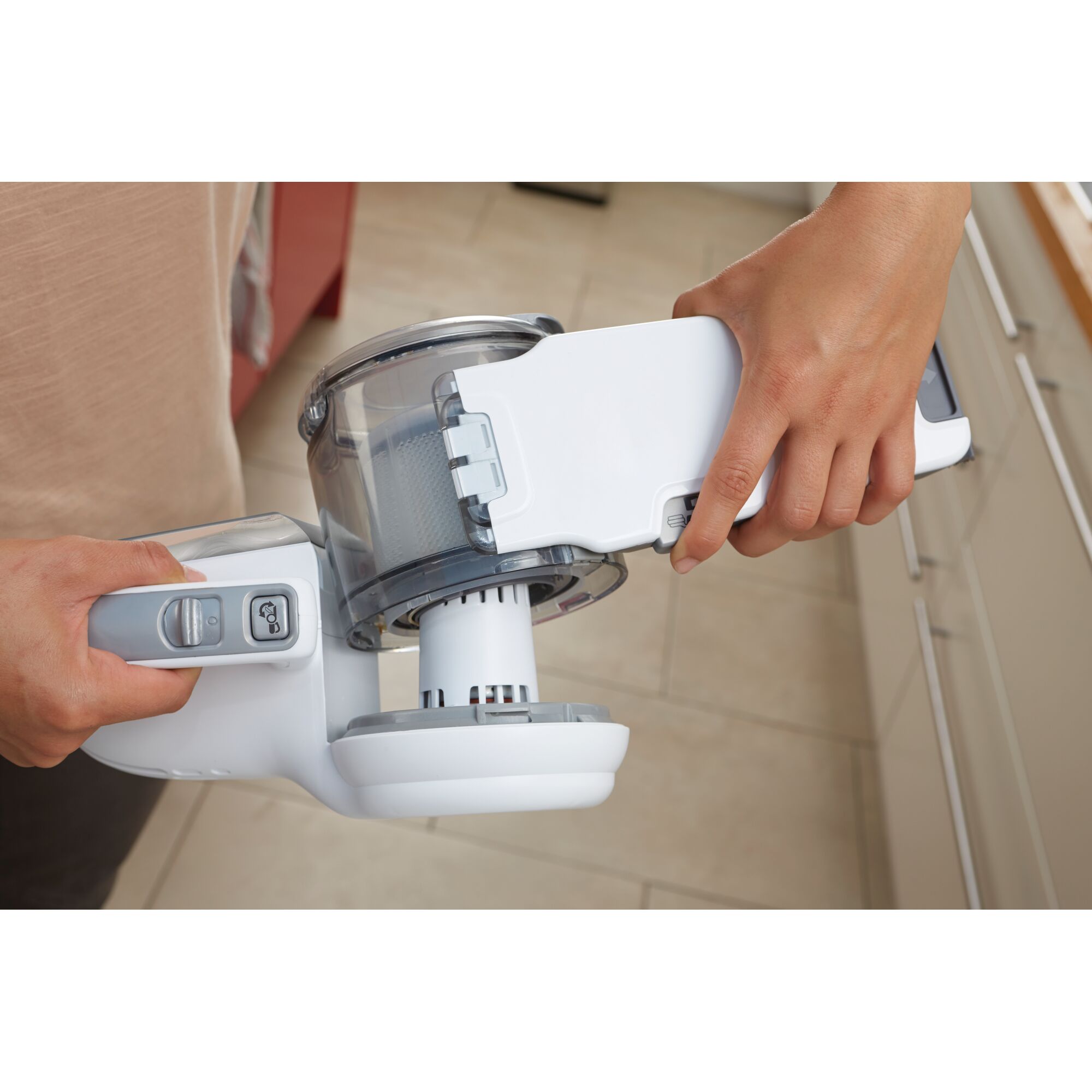 BLACKDECKER PV1020CAC handheld vacuum filter being removed, close-up in kitchen setting.
