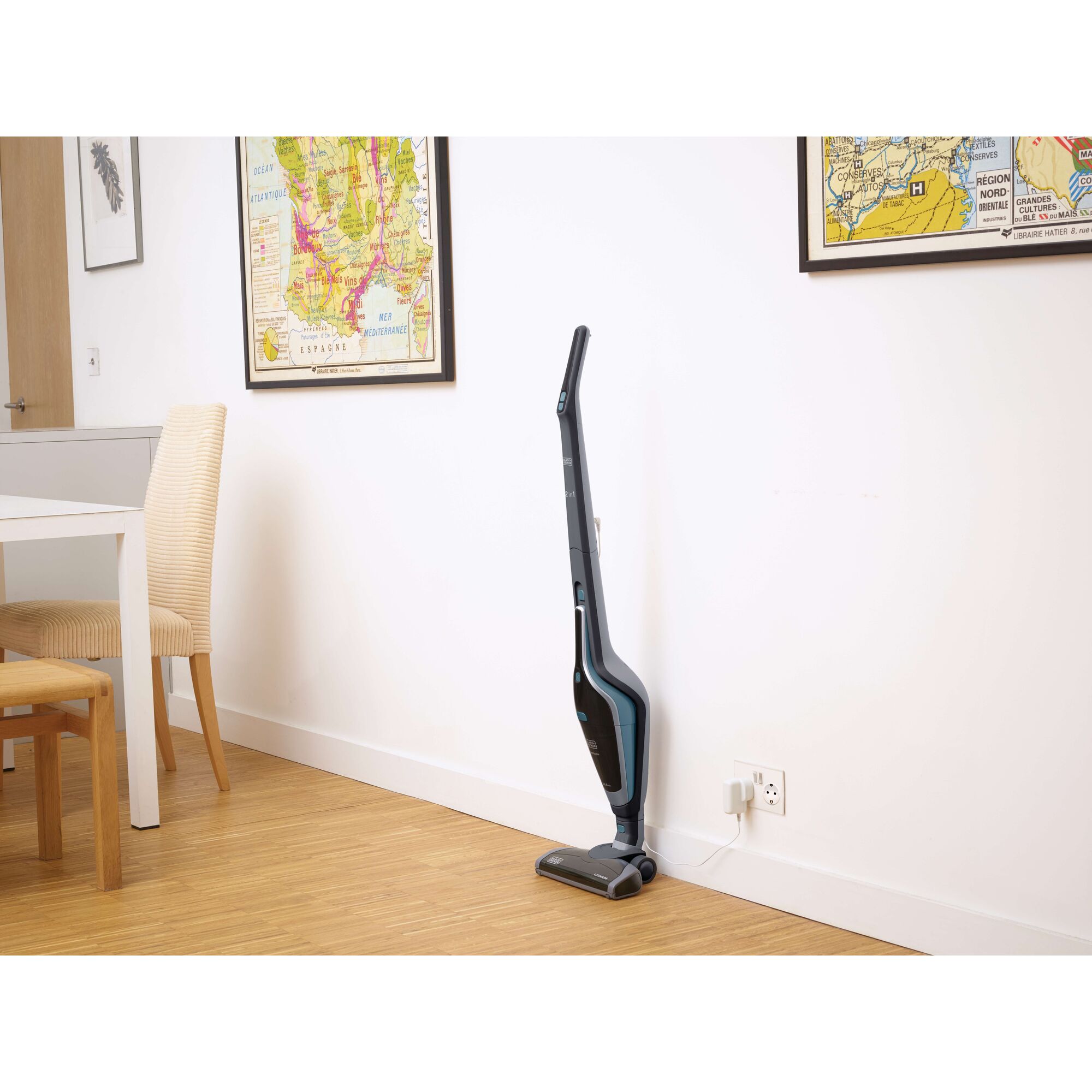 BLACKDECKER SVA420B cordless stick vacuum charging by wall in modern dining room.
