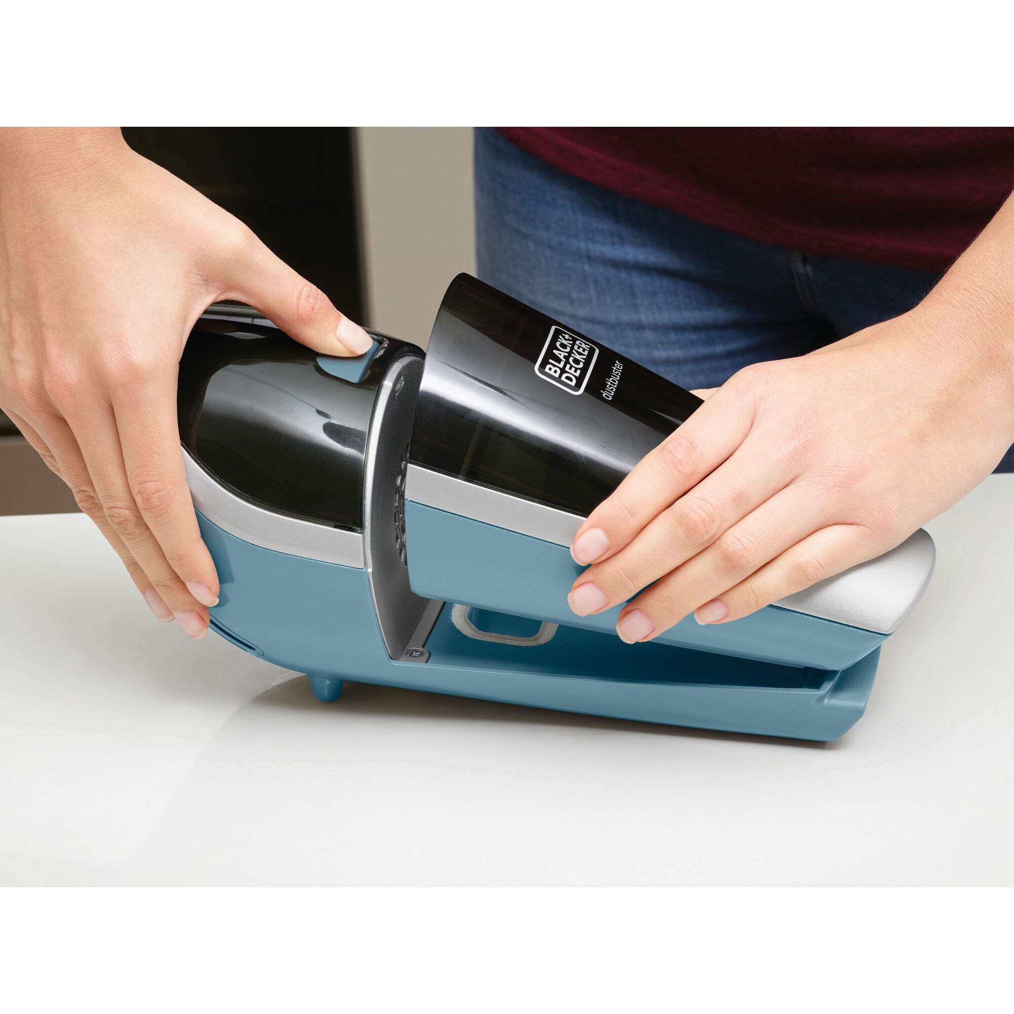 BLACKDECKER SVA420B handheld vacuum photography, close-up showing blue and black device being removed from base.