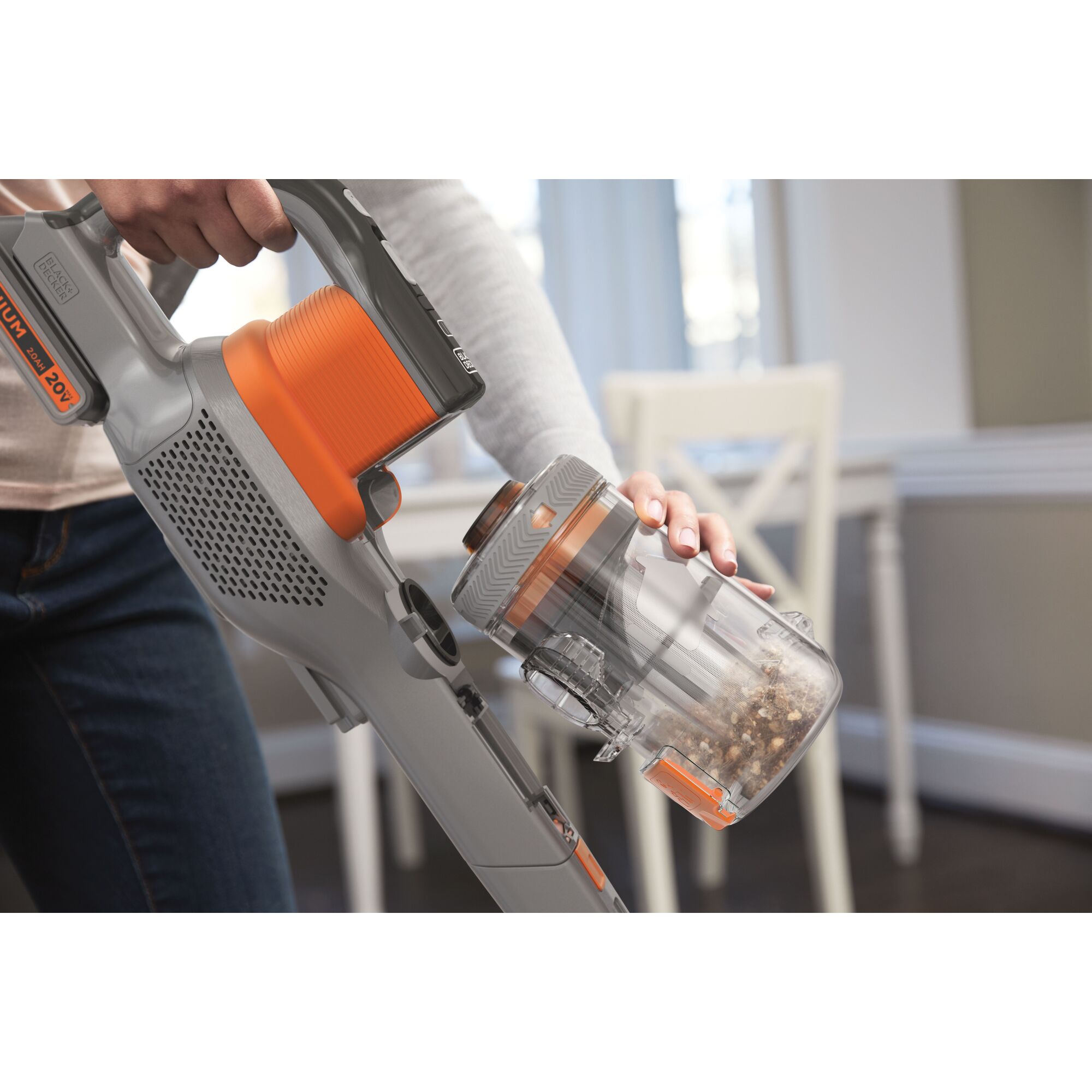 BLACKDECKER TBSV2020S stick vacuum cleaner with removable dust bin, shown in a home setting.