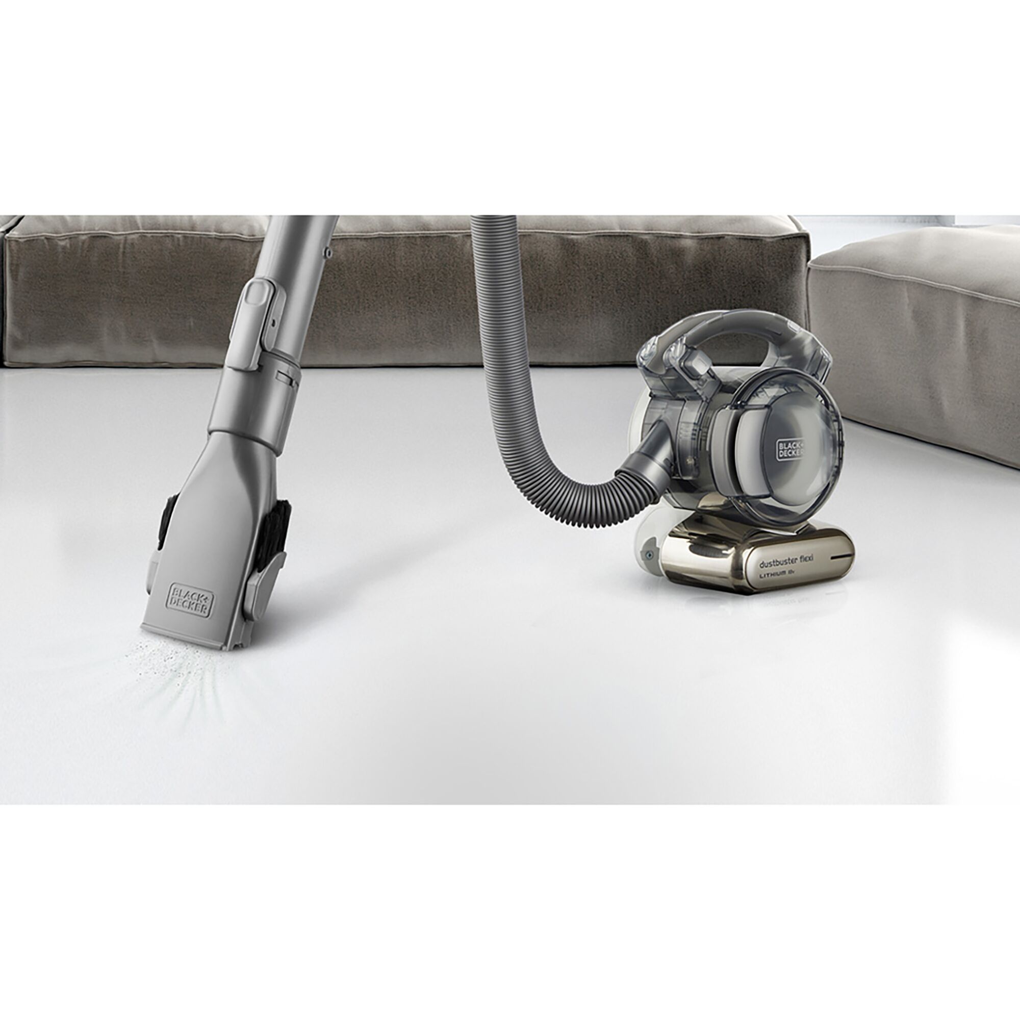 Photo of BLACKDECKER TPD1810BGEXT-KR handheld vacuum cleaner with hose attachment cleaning white surface.