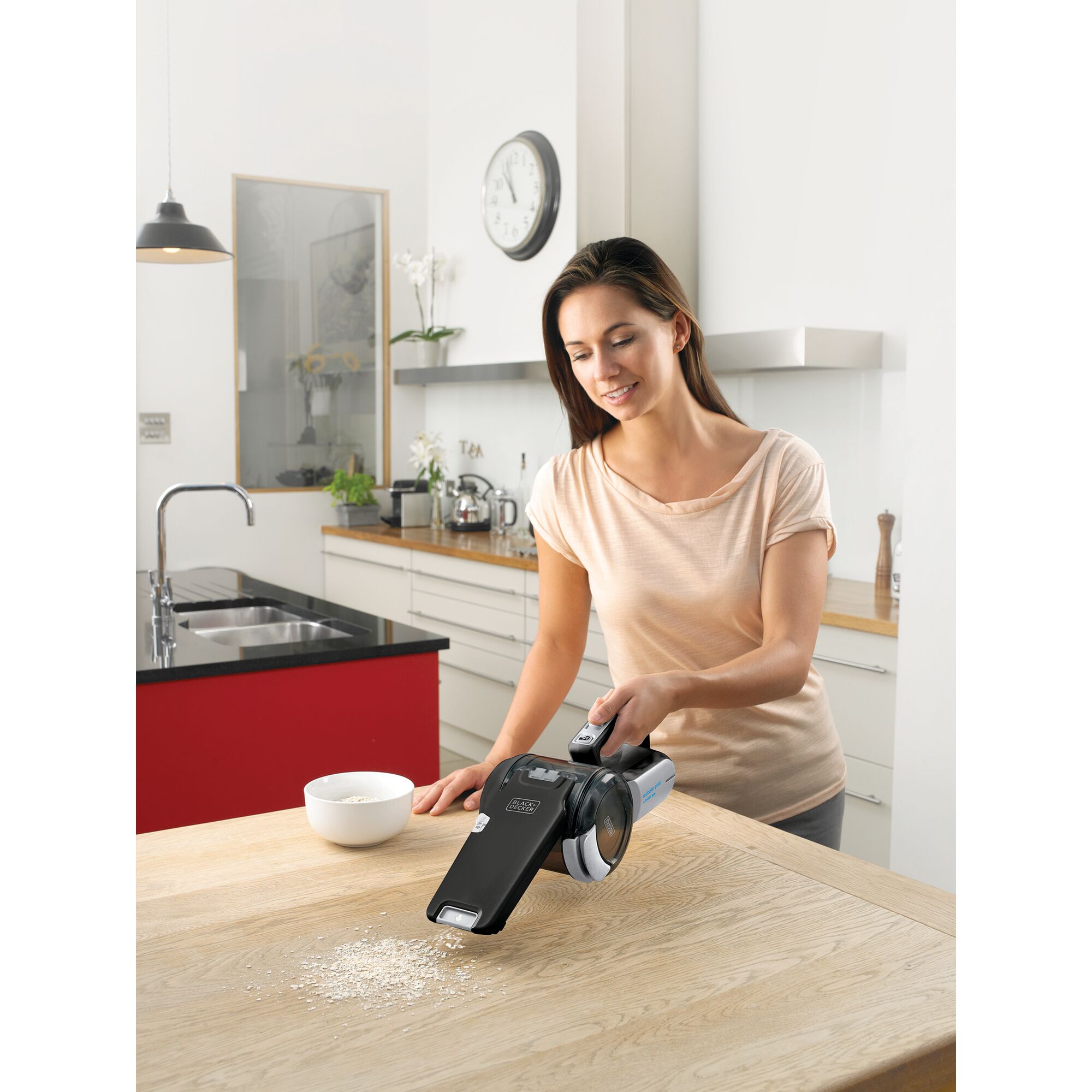 BLACKDECKER TPV1020BOAC handheld vacuum cleaner cleaning kitchen table near bowl of oats.