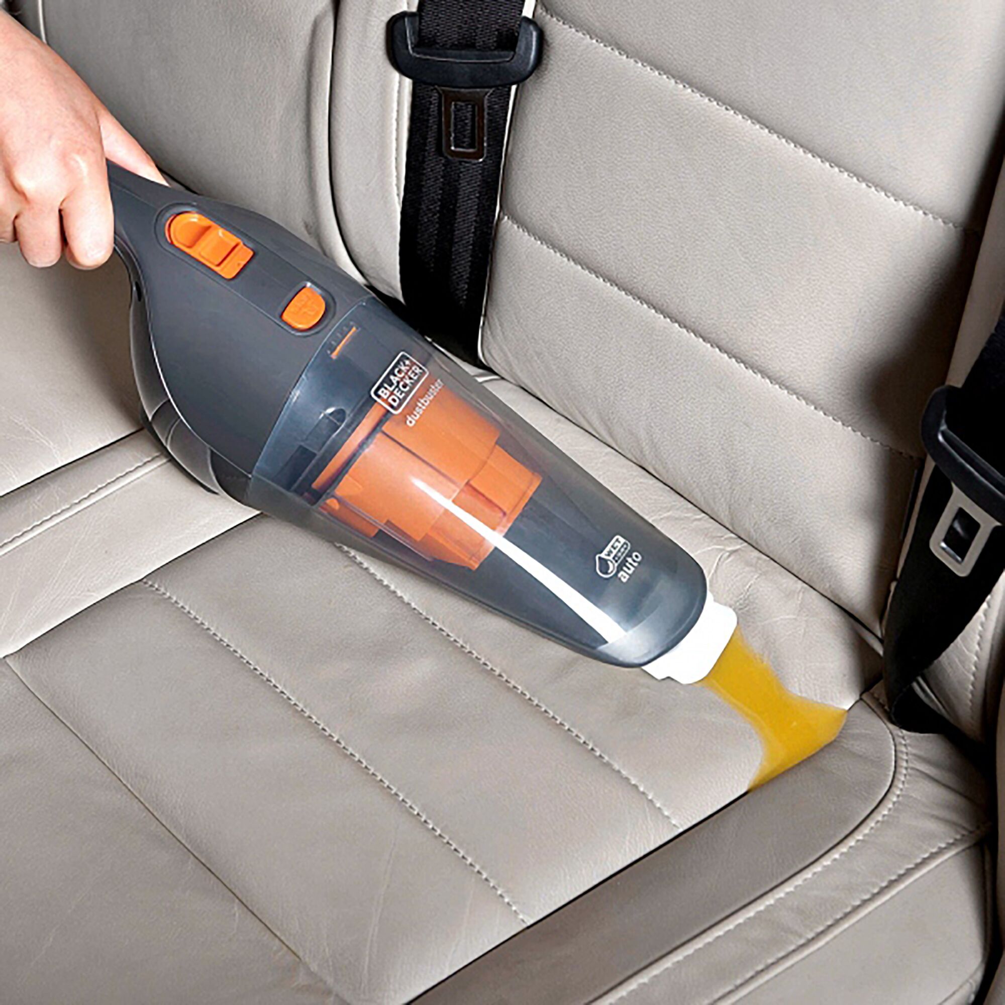 BLACKDECKER WD1210AV handheld vacuum cleaning car seat upholstery with orange nozzle attachment.