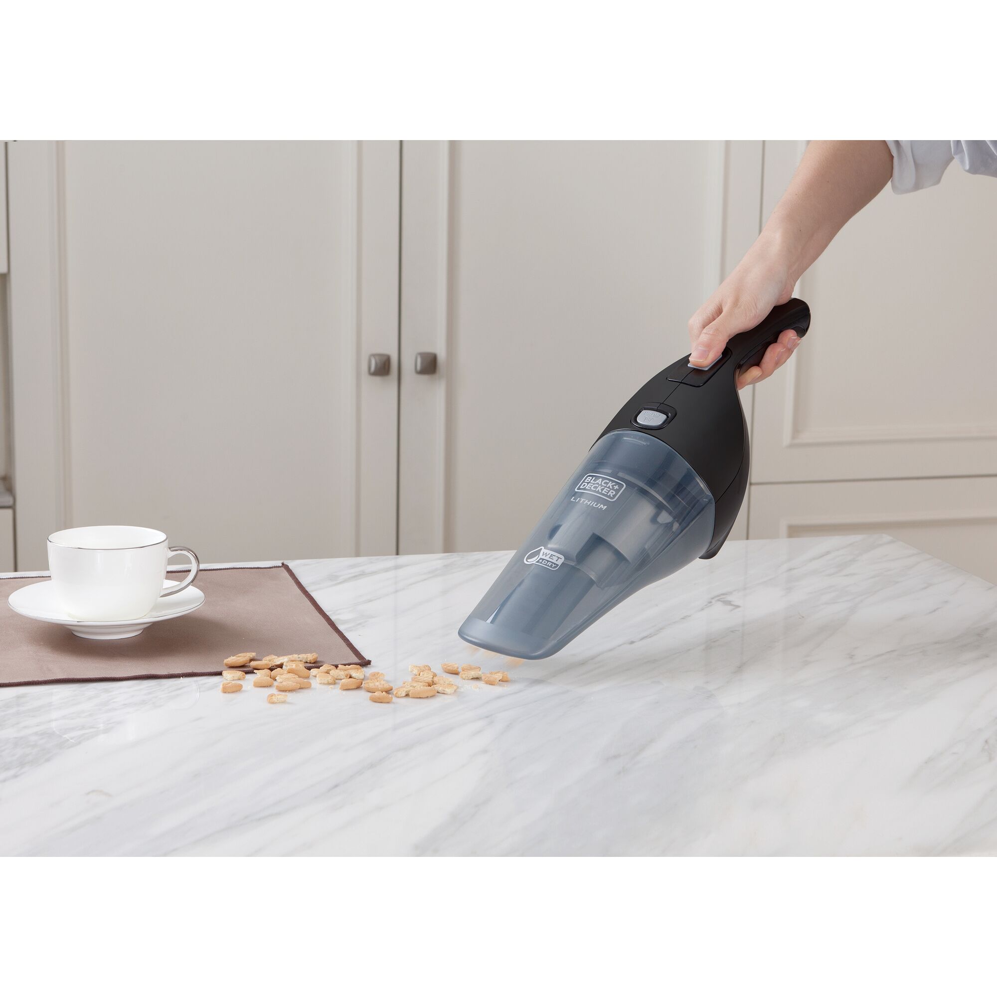 BLACKDECKER handheld vacuum WDB215WBK cleaning crumbs on marble kitchen counter.