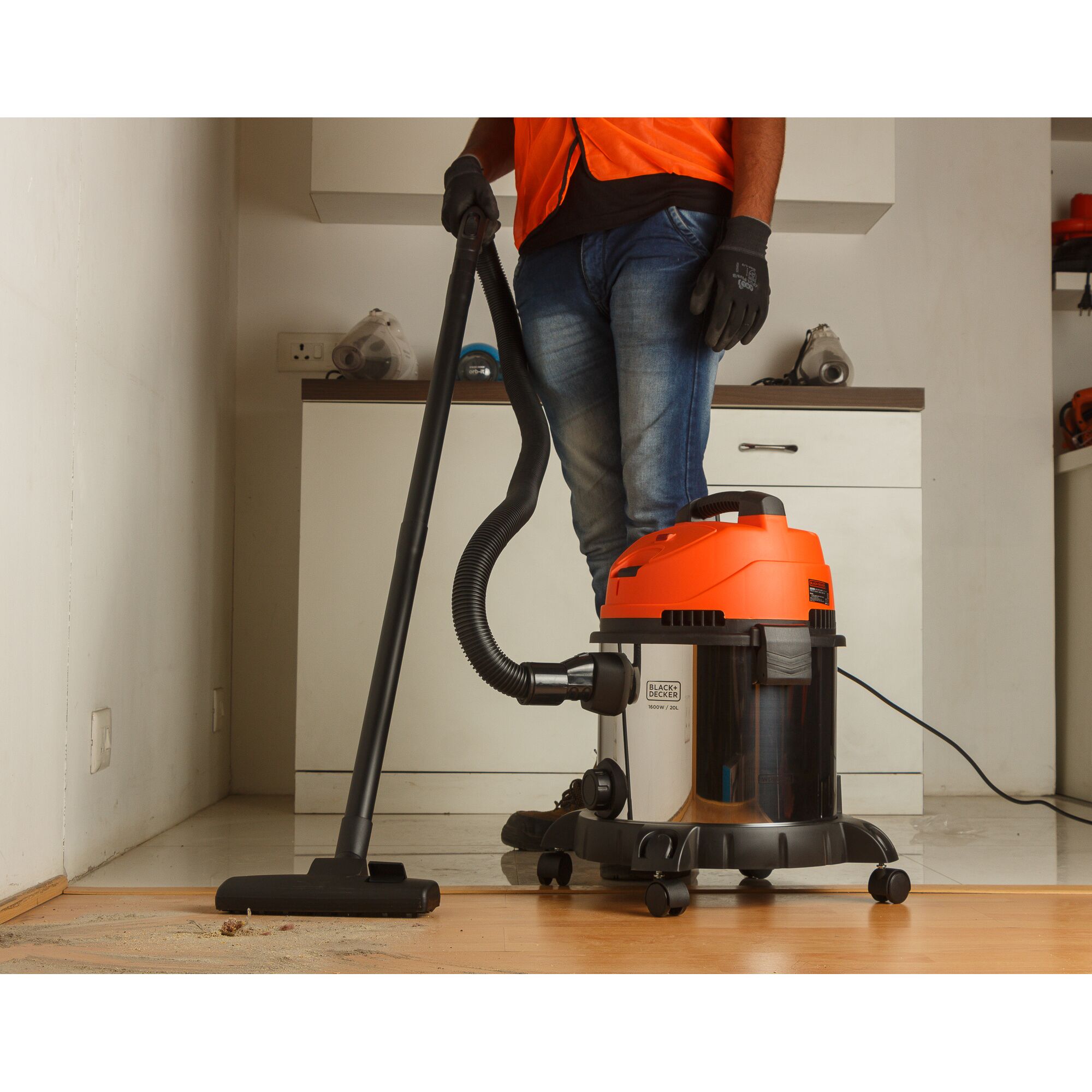 BLACKDECKER WDBDS20 wet and dry vacuum cleaner in use in a modern indoor space, with visible floor debris.